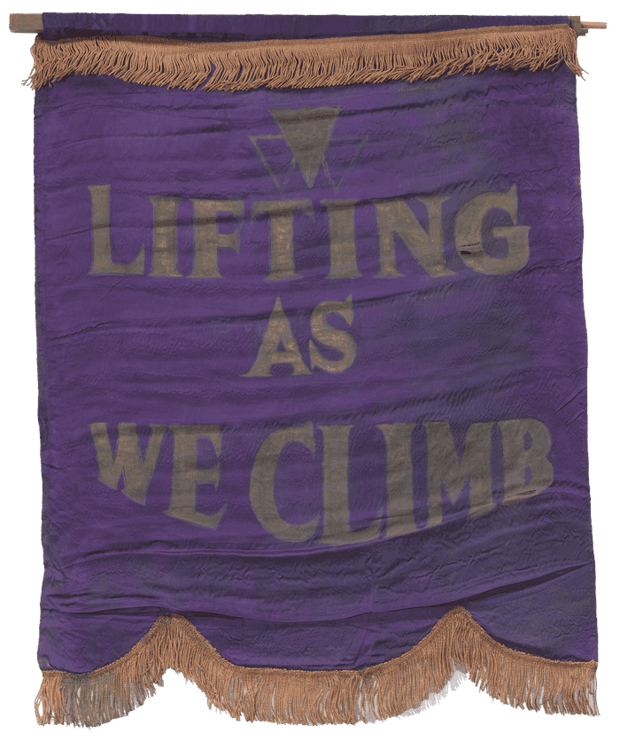 A purple silk banner with gold fringe and the National Association of Colored Women’s Clubs' motto, "LIFTING / AS / WE CLIMB" painted in large gold letters.