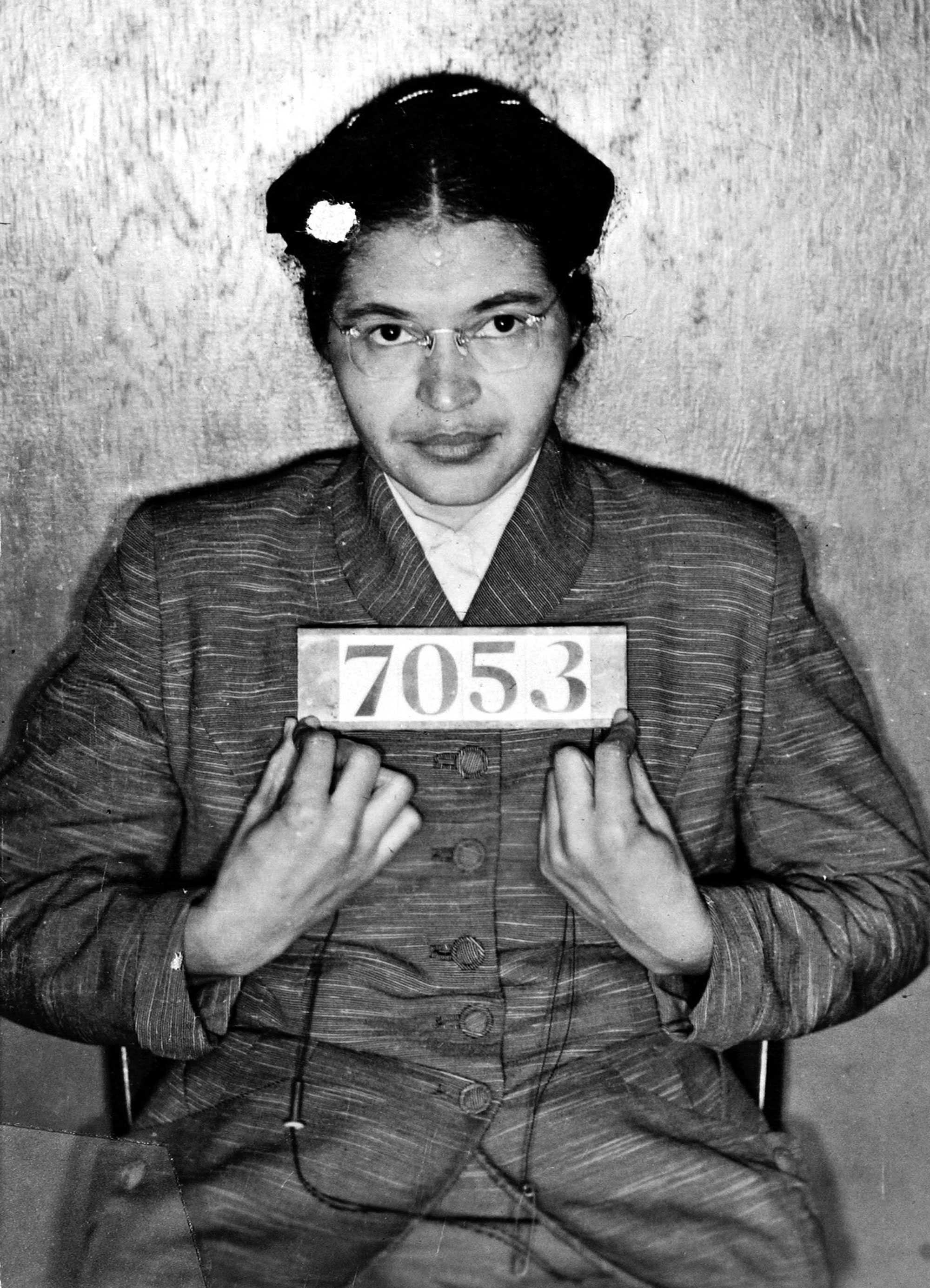 Rosa Parks holds an prisoner ID number sign as she poses for a mug shot.