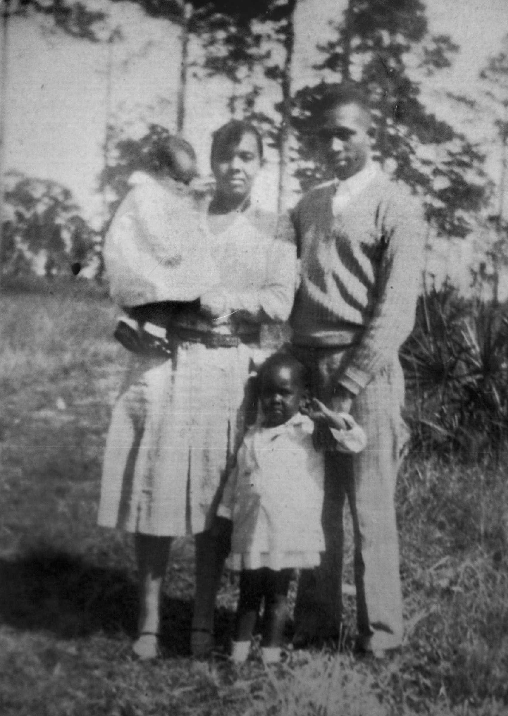 A black and white photograph of Harry and Harriette Moore with their 2 children.