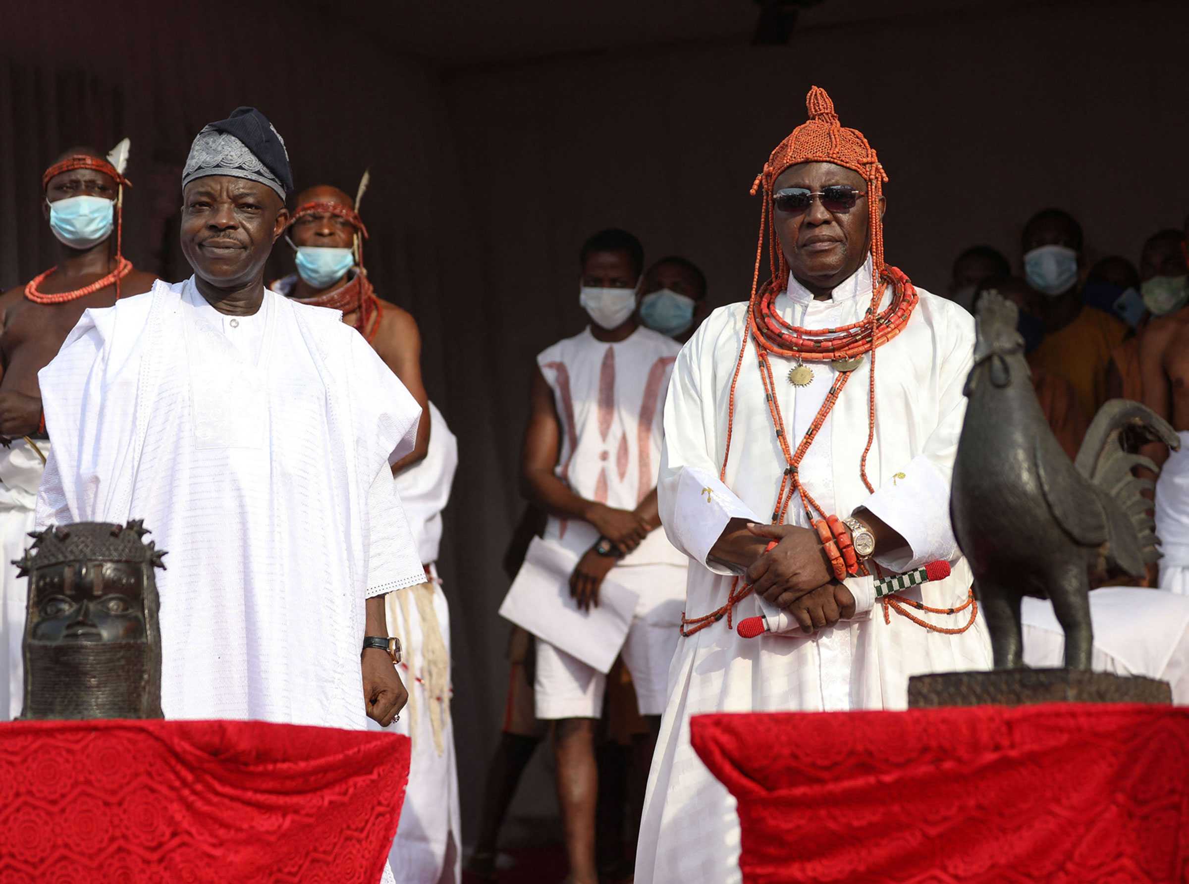 The King and Nigeria High Commissioner to the United Kingdom , pose for a photo while receiving repatriated artifacts.