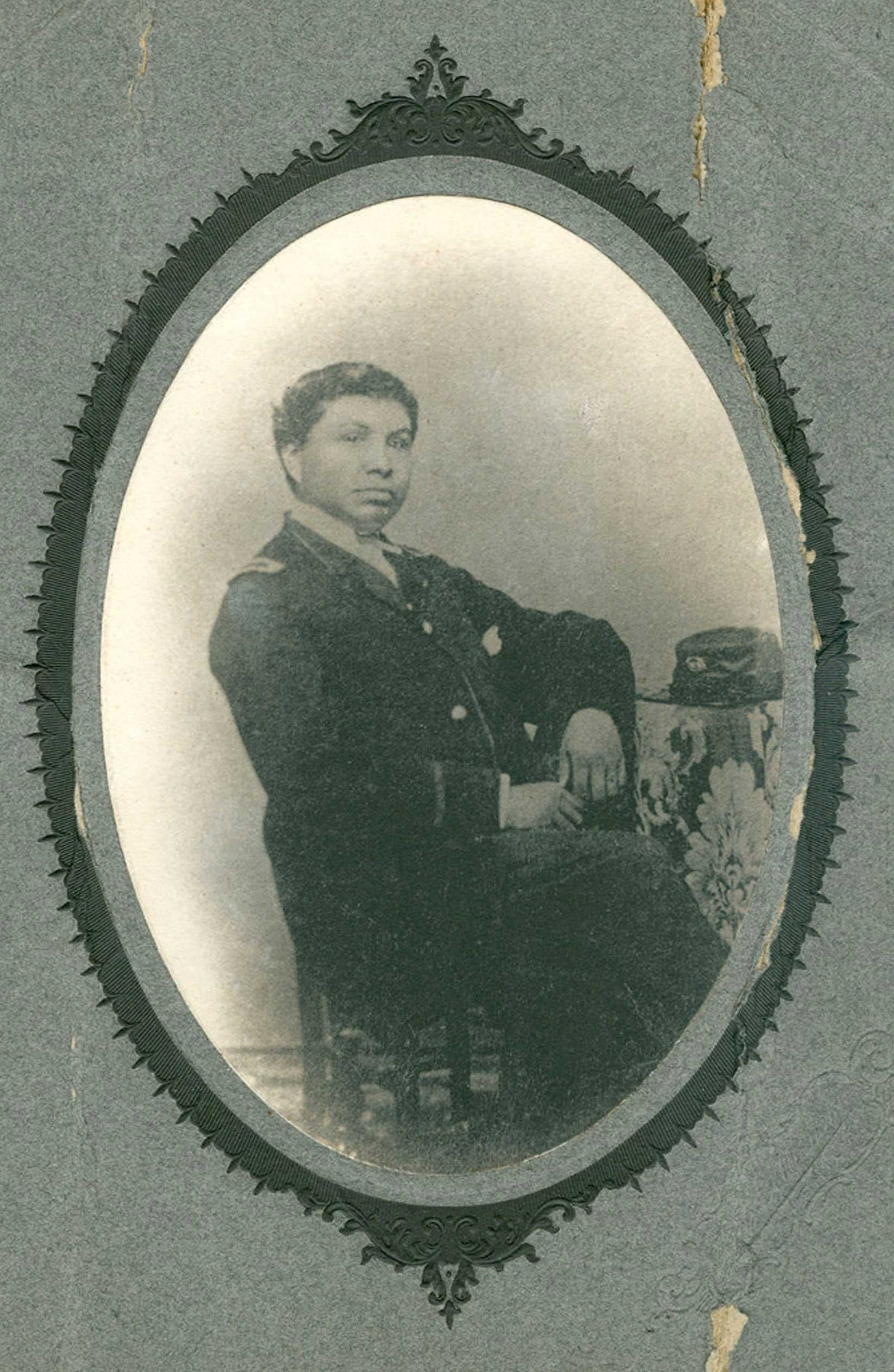 A portrait of William Peter Powell, Jr. He is sitting at a chair in a U.S Army uniform.