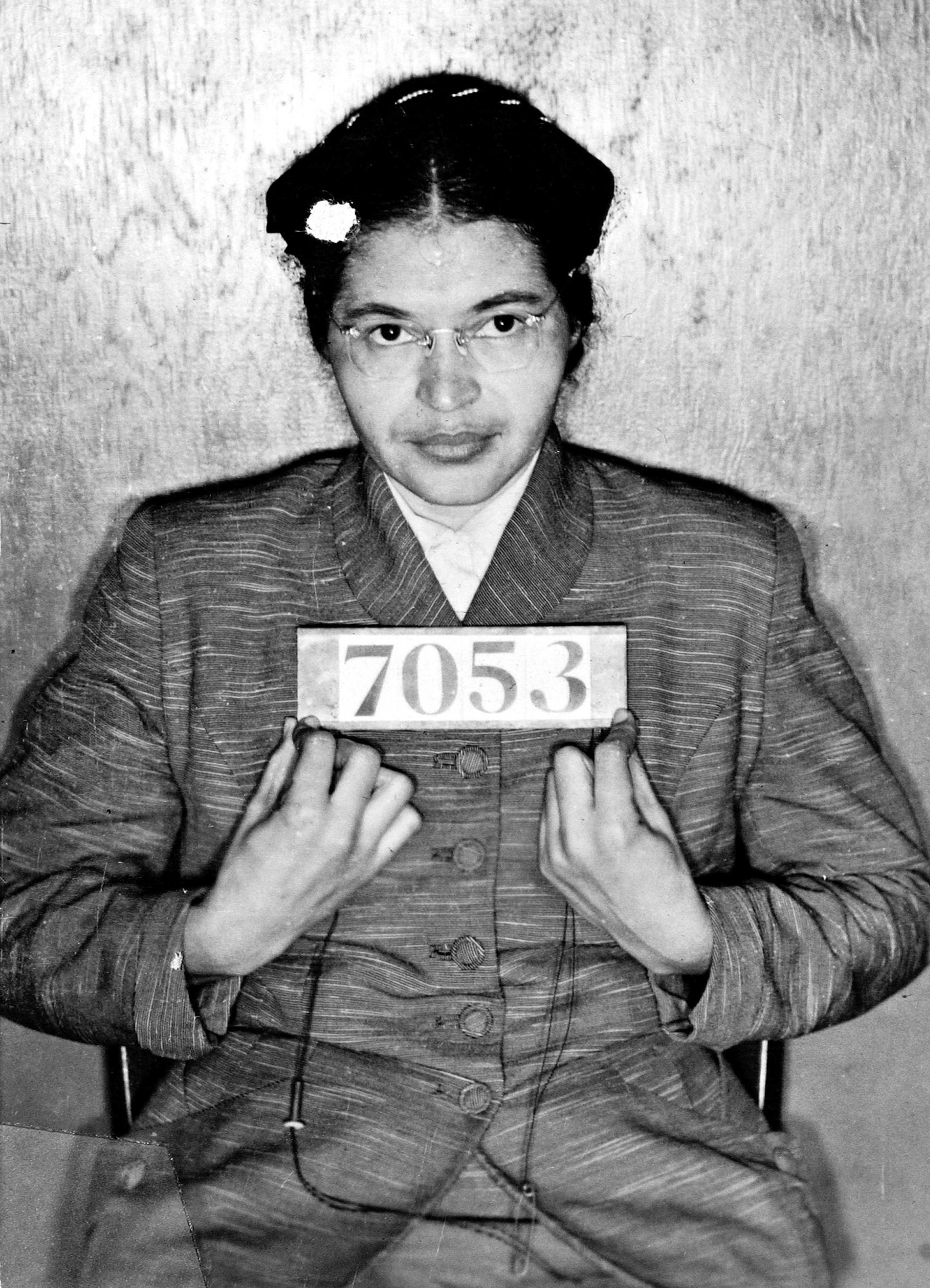 Rosa Parks holds an prisoner ID number sign as she poses for a mug shot.