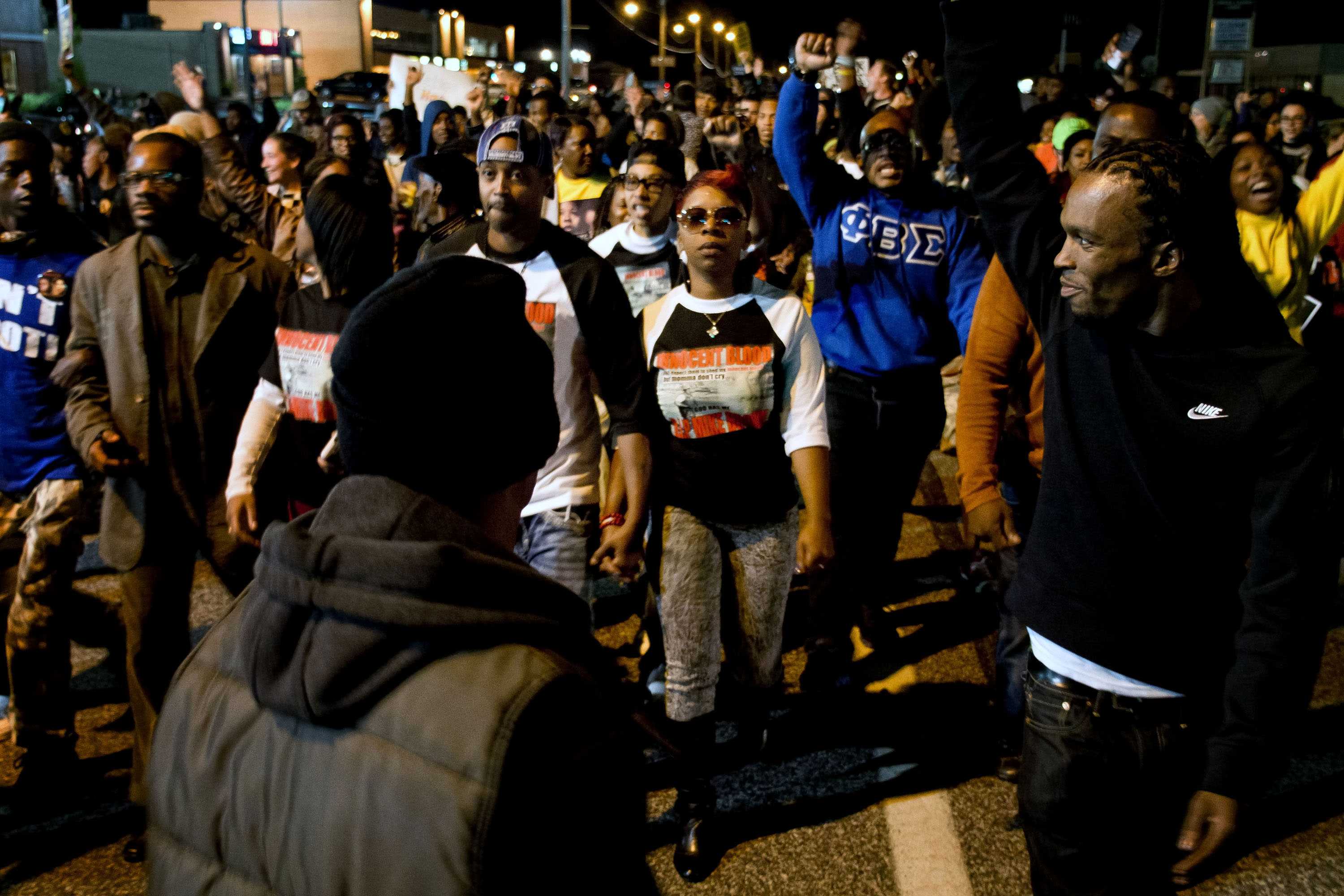 Among Protestors, Lesley McSpadden in center in "INNOCENT BLOOD" shirt, holding hands with Louis Head.