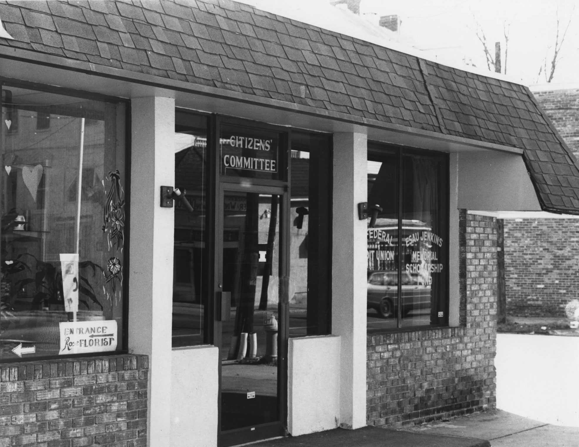 A black and white photograph of the outside view of the Esau Jenkins Credit Union building.