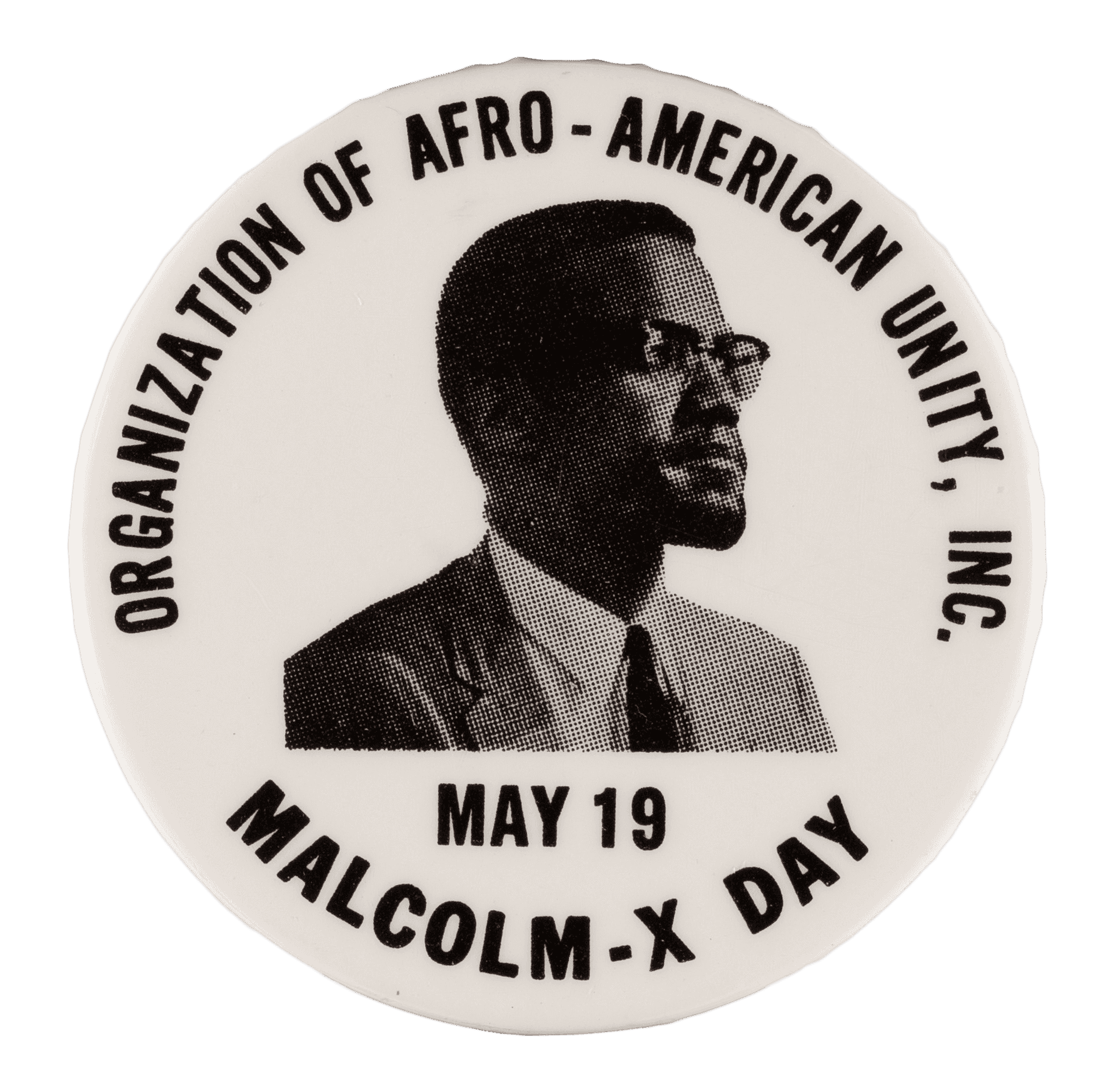 A white pin back button with a black and white image of Malcolm X. Malcolm X is seen from the shoulders up