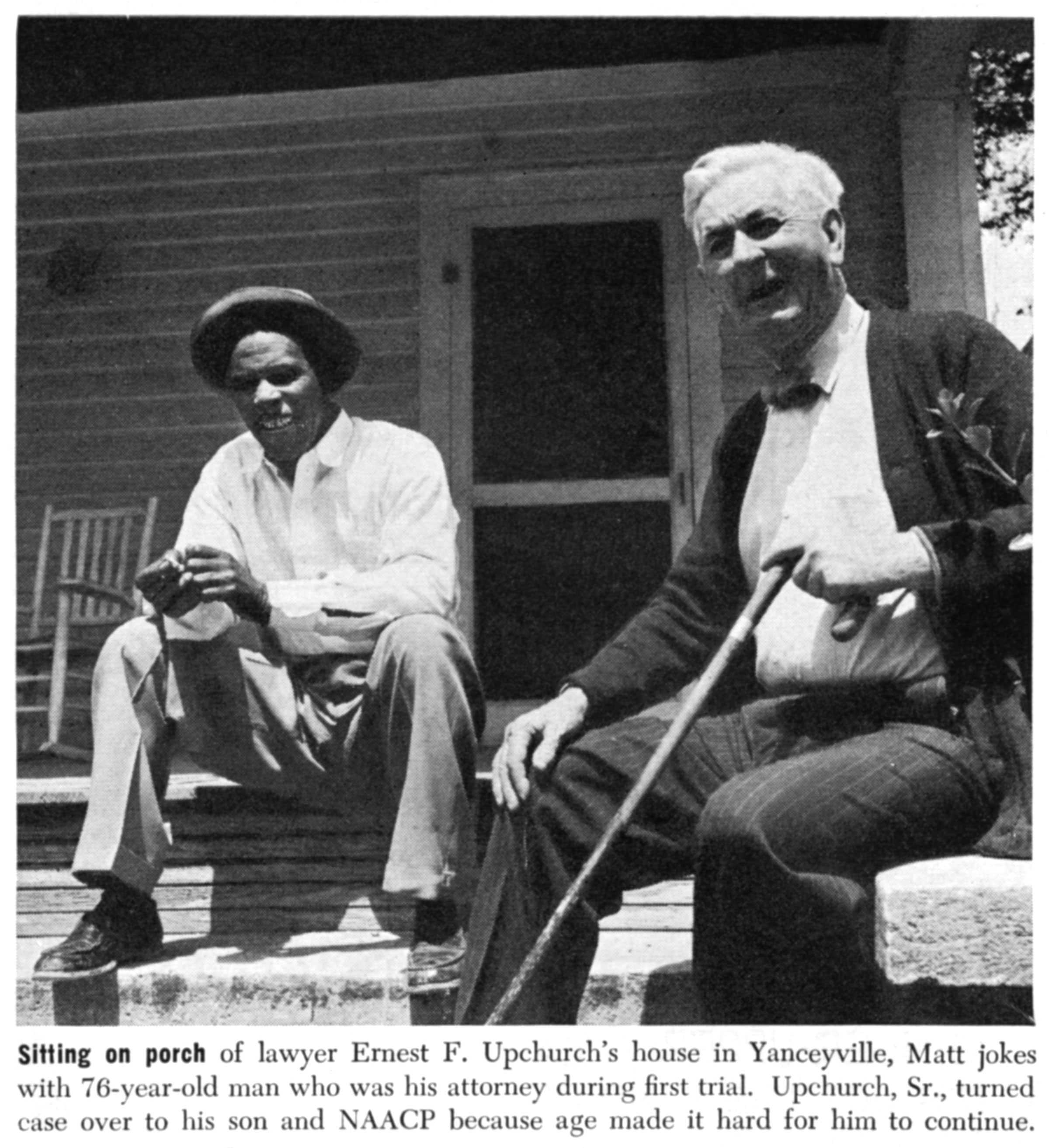 A newspaper clipping of Matt Ingram sitting on porch with lawyer, Ernest F. Upchurch, who is an older white man.