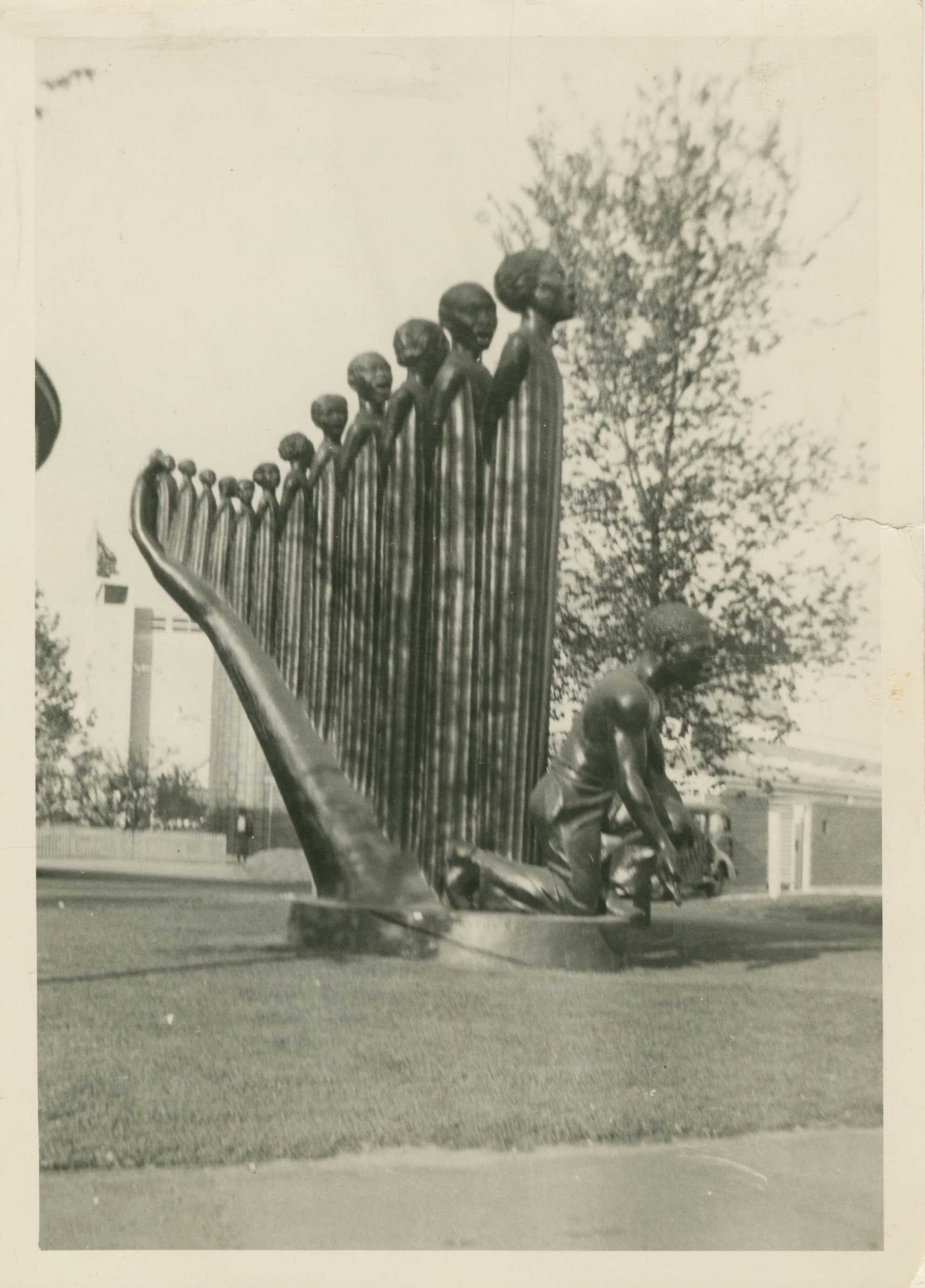 Black and white photograph of the side profile of Augusta Savage's 16-foot sculpture, "Lift Every Voice and Sing."