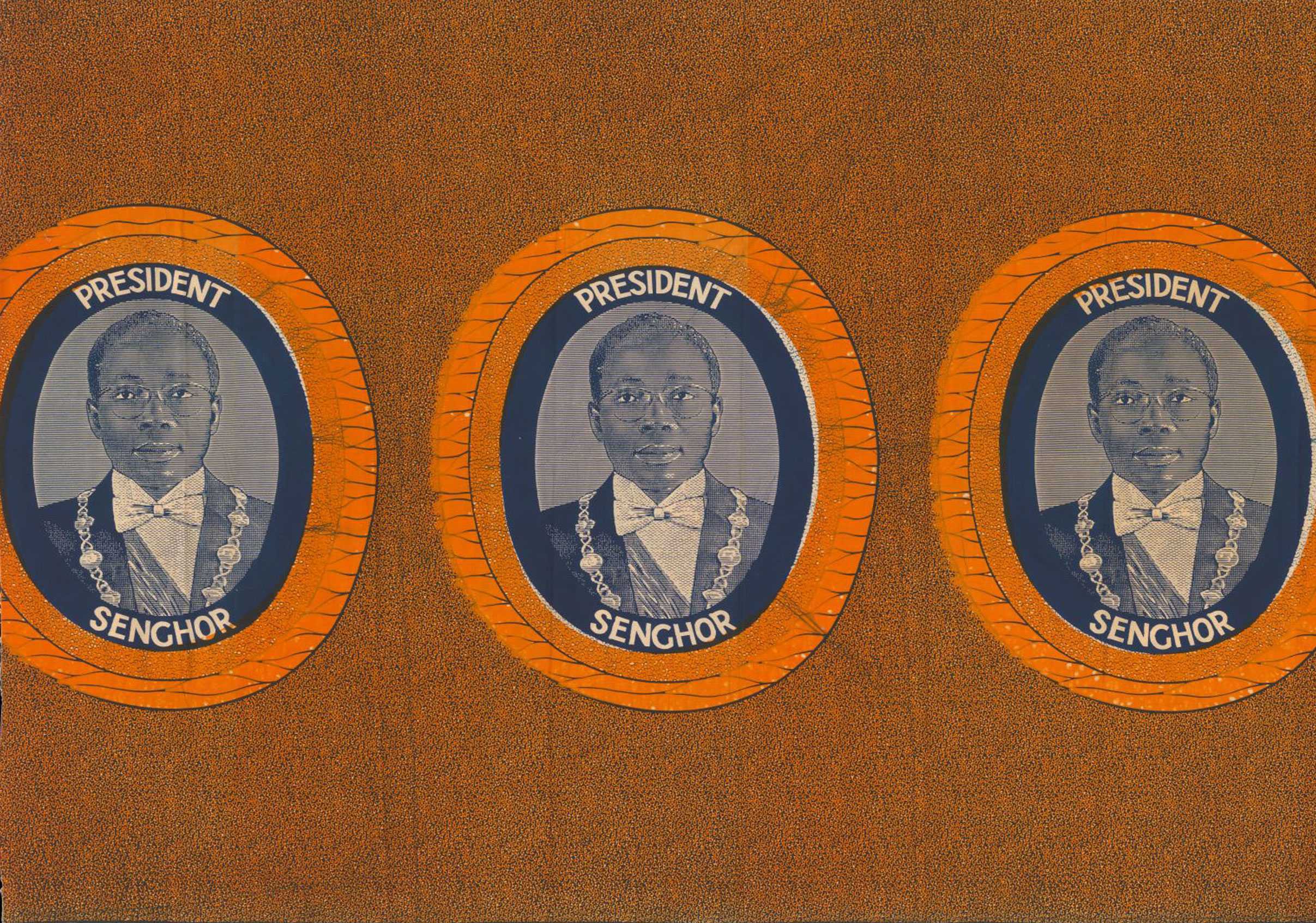 An orange fabric with 3 portraits of Leopold Senghor. His portrait is in oval and in blue.