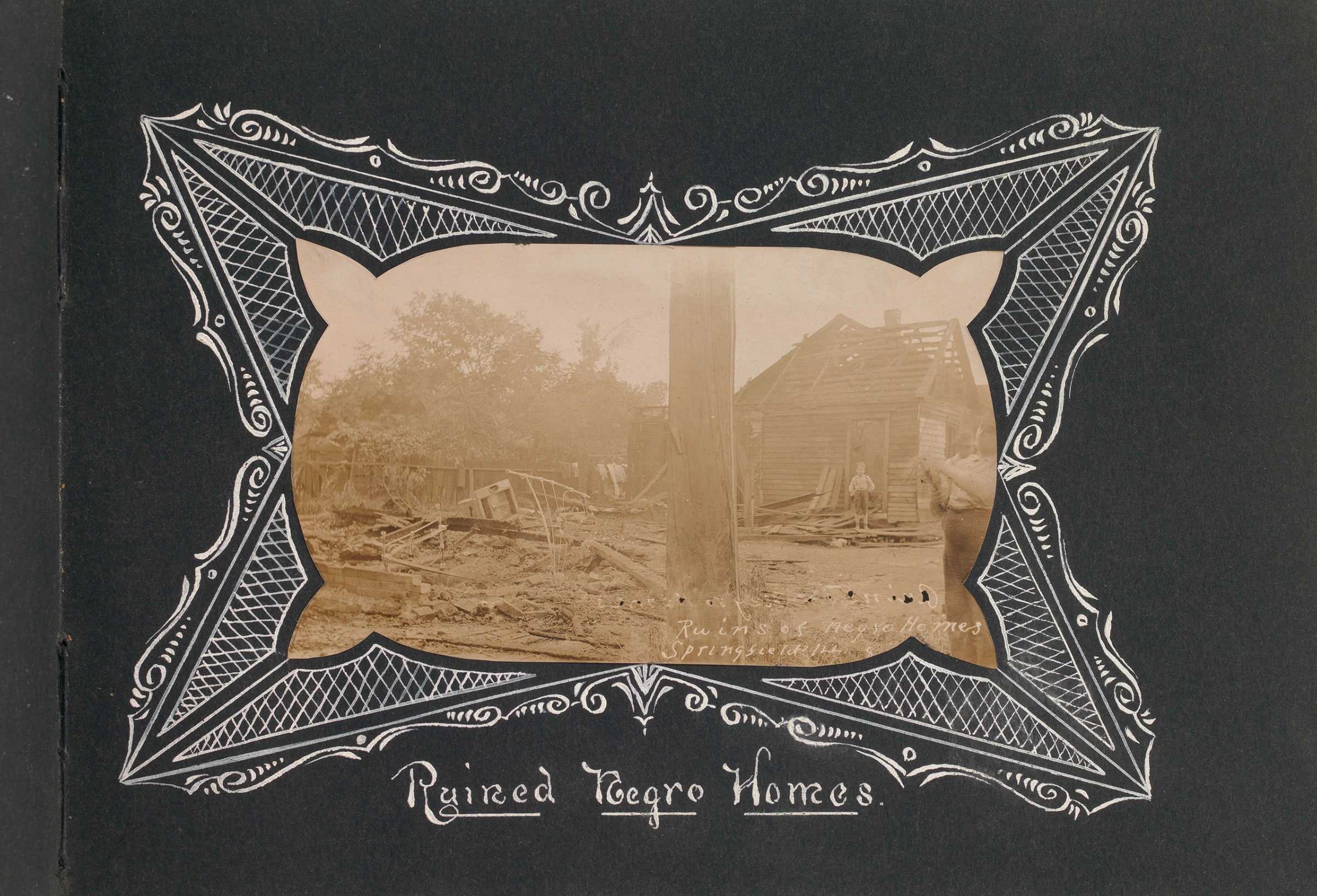 Black photograph album with sepia-toned photos of a destroyed building in Springfield Illinois race riot aftermath with hand-drawn captions.