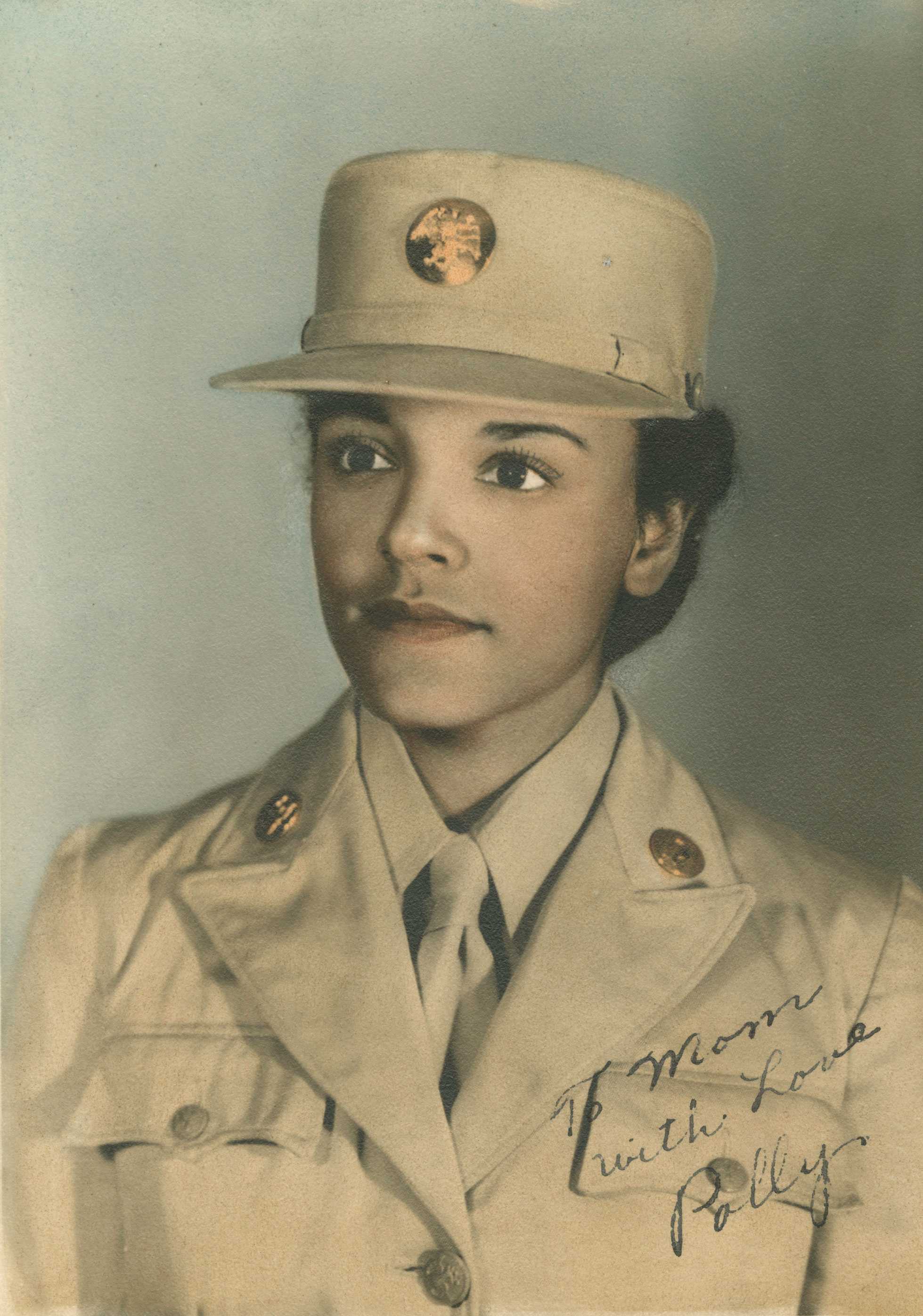 Hand tinted photo of a Women's Army Corps soldier in khaki uniform, inscribed "to mom love Polly" in front.