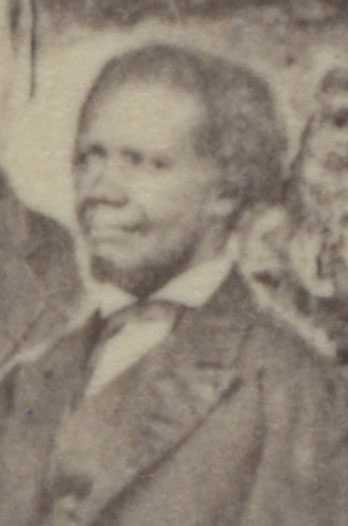 A blurry sepia tone photo of Edward C. Mickey. He is wearing a suit and white dress shirt.