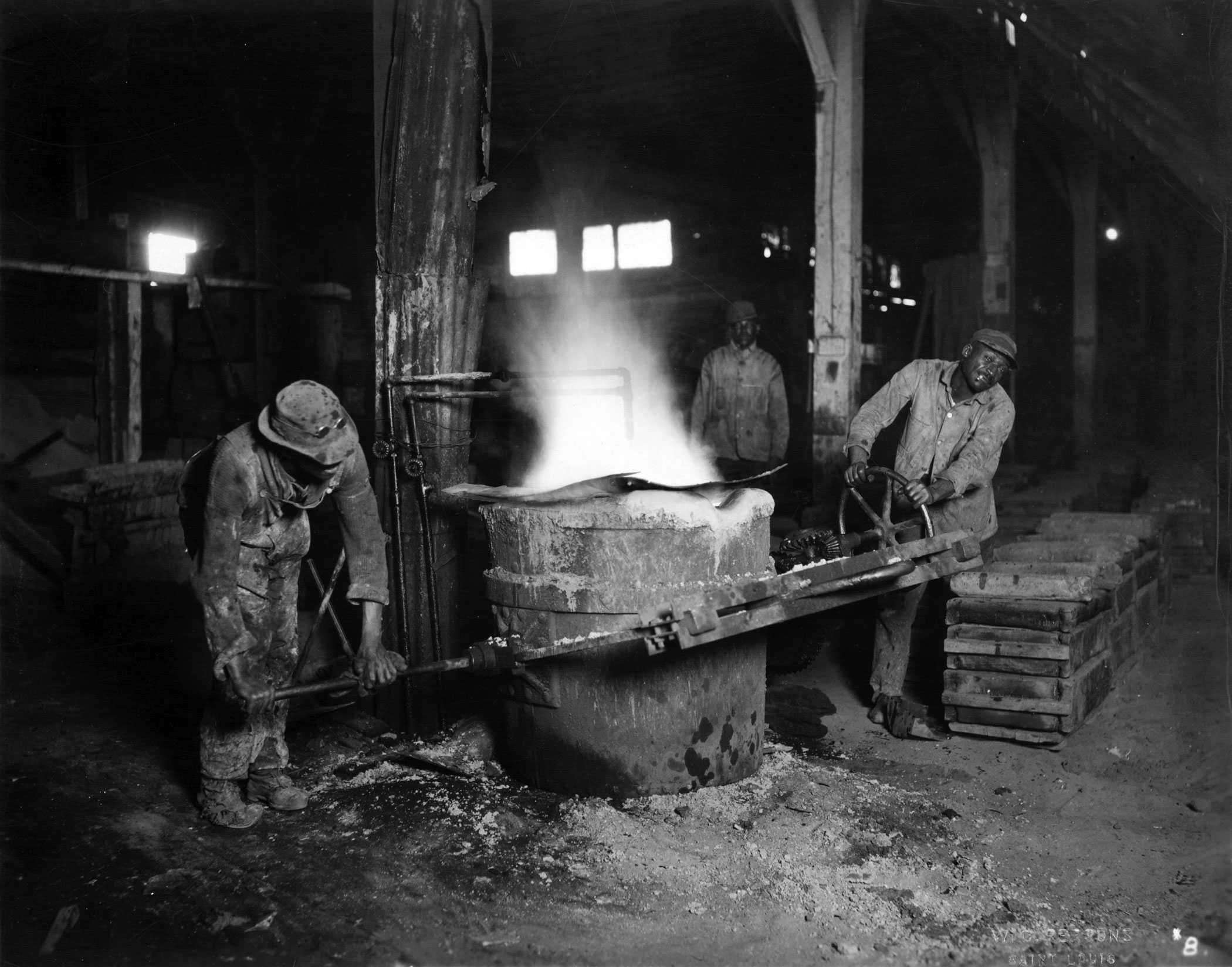 Black and White photograph of 3 African American men working inside a factory.