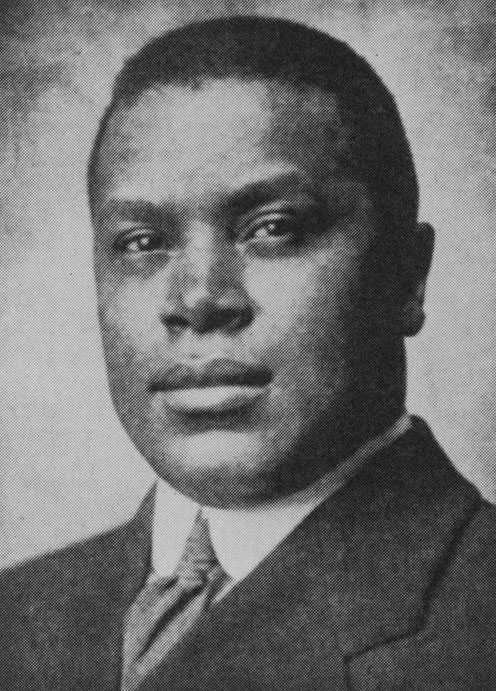 Black and white portrait of an African American man with short hair.