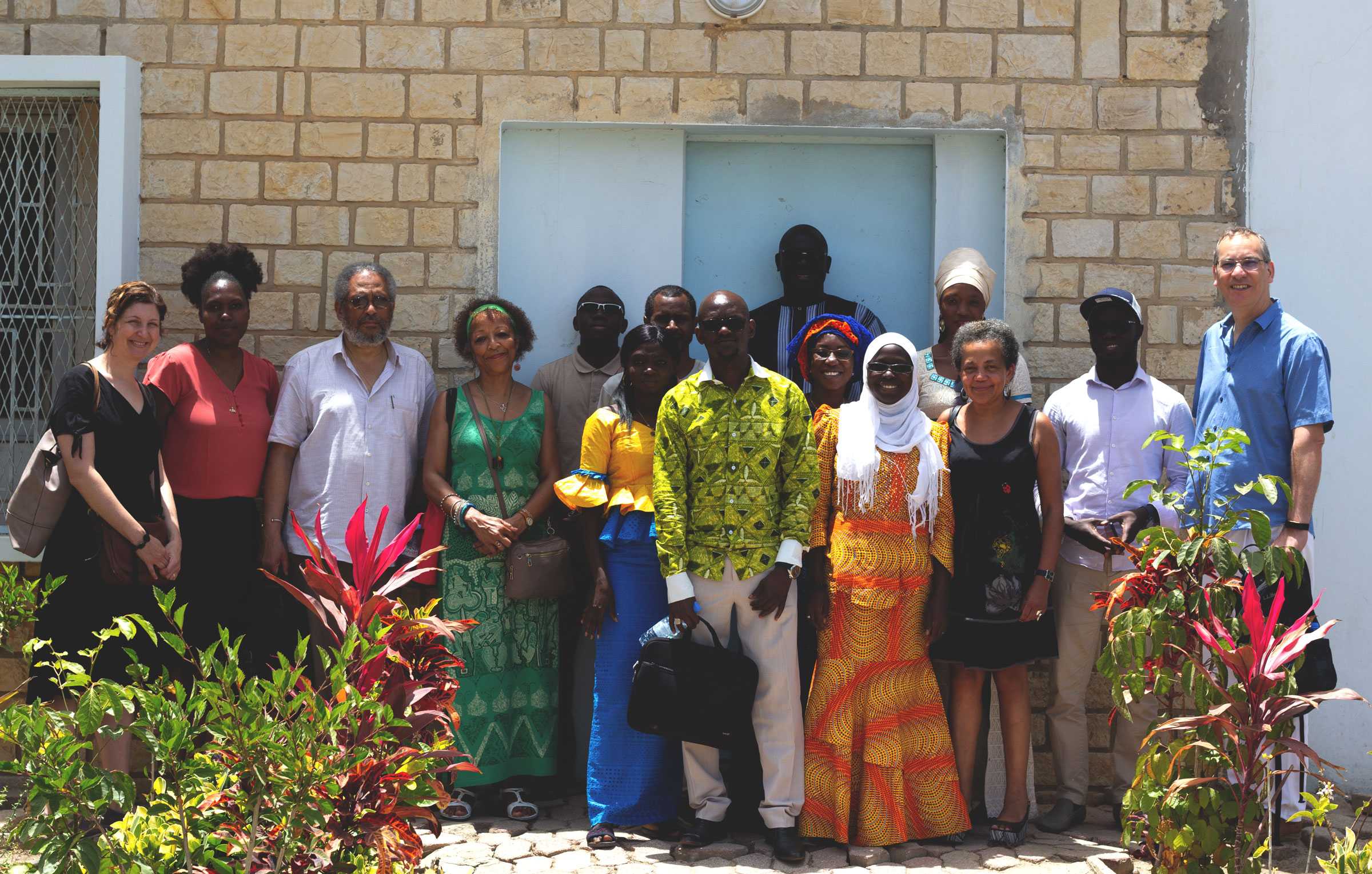 A group photograph of project members in Senegal, outside a small structure.