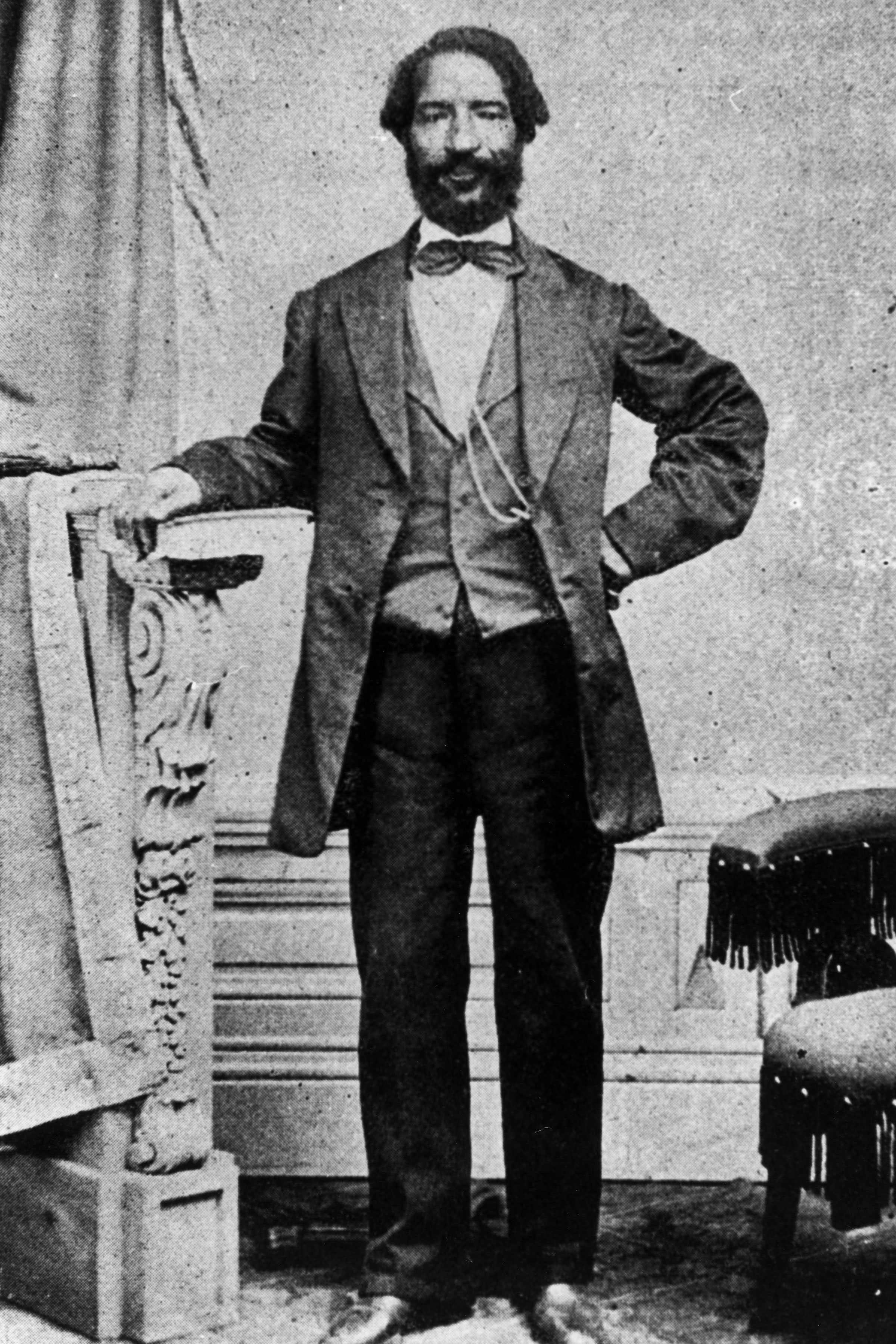 Full length portrait of a man dressed in formal clothing.