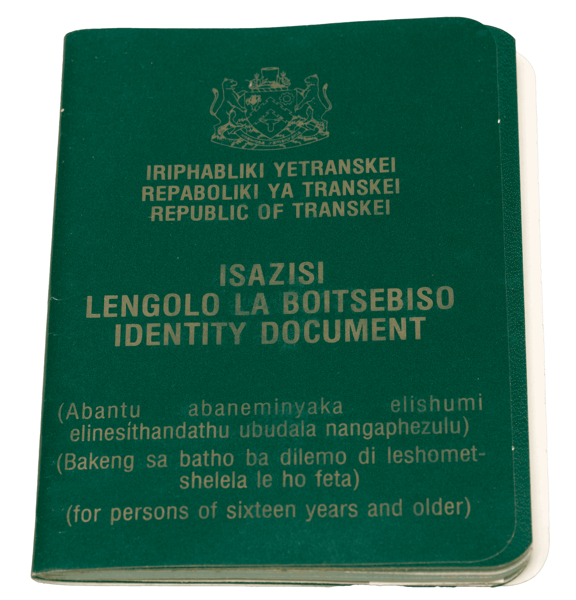 The cover of a green thin passport. The state name Transkei, passport title, and age restriction for 3 different languages.