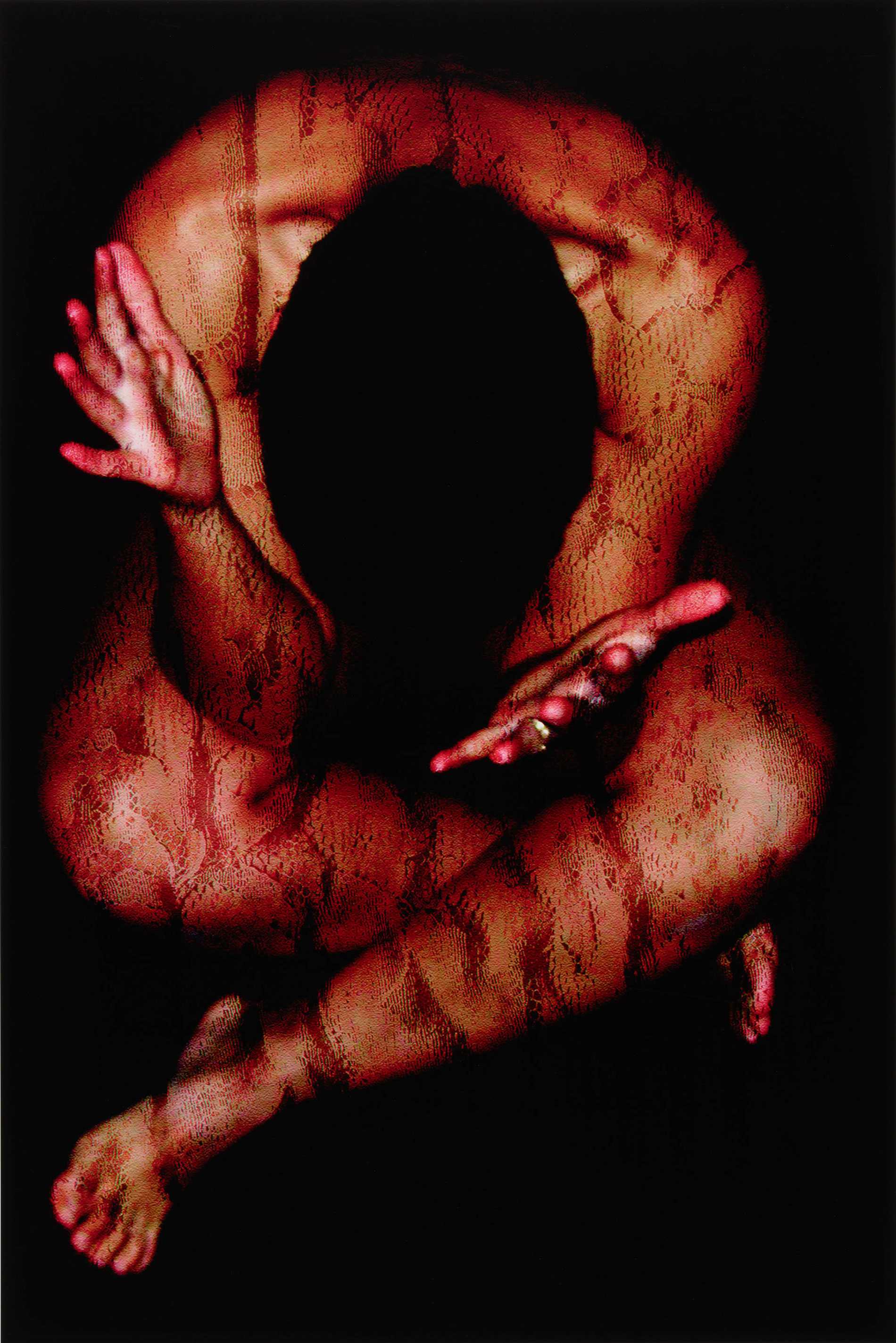 A nude woman, cross-legged, hunched over, showing the top of her head, with red-tipped fingers, scaly skin.