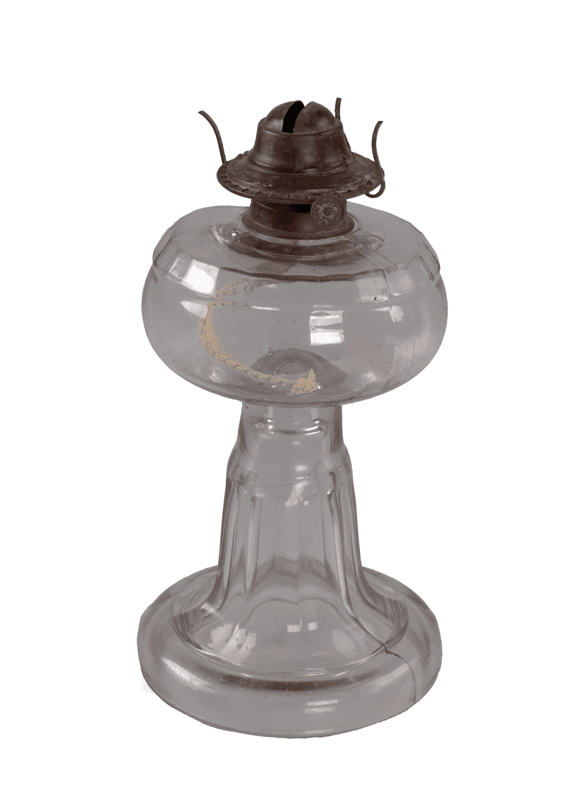 A clear glass oil lamp base. The body is a lozenge shape that connects with a thick lamp stem.