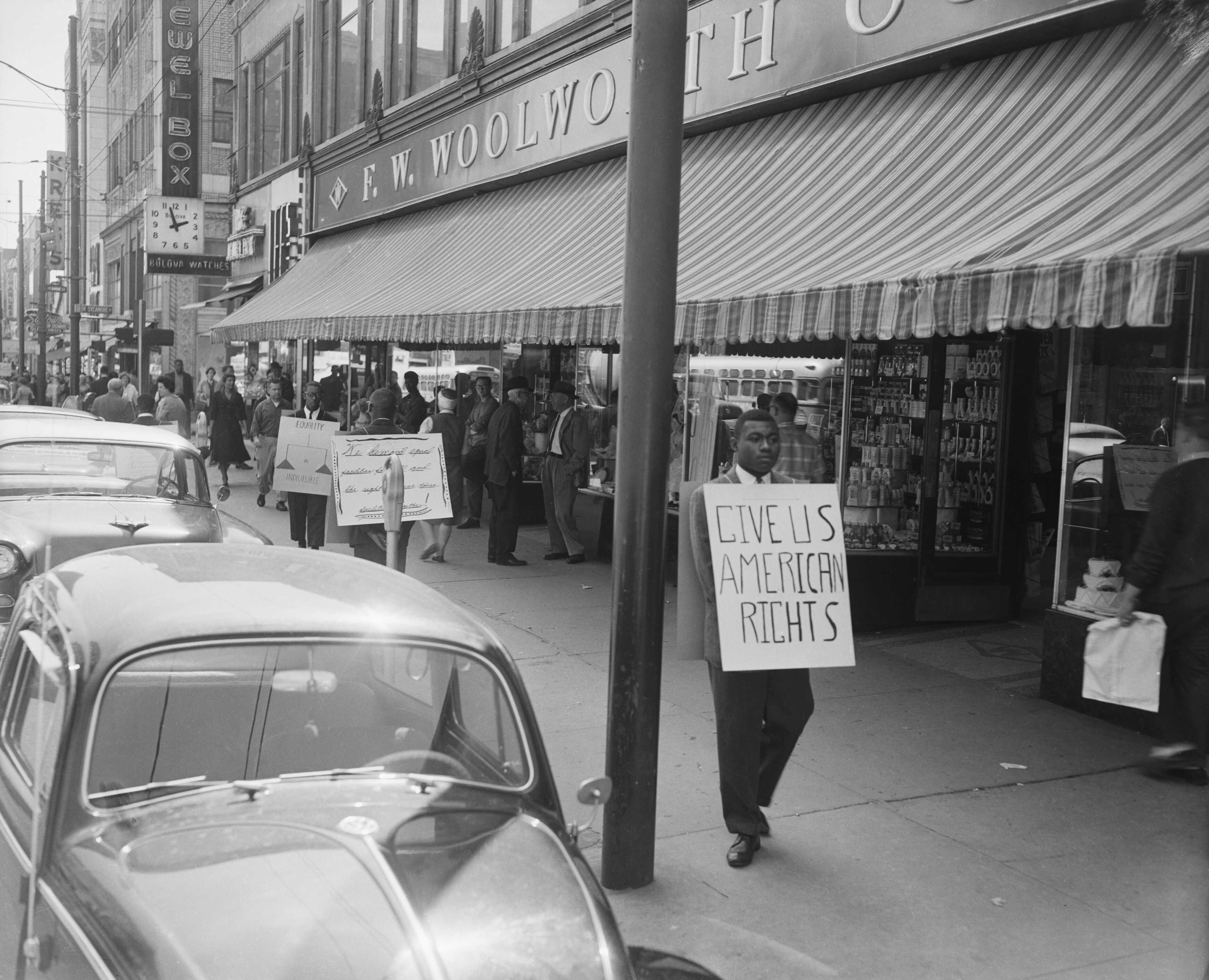 Black and white photograph of picketers outside a Woolworth's.