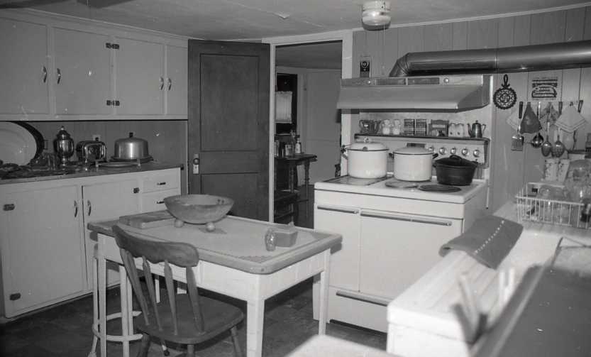 Black and white photograph of a kitchen.