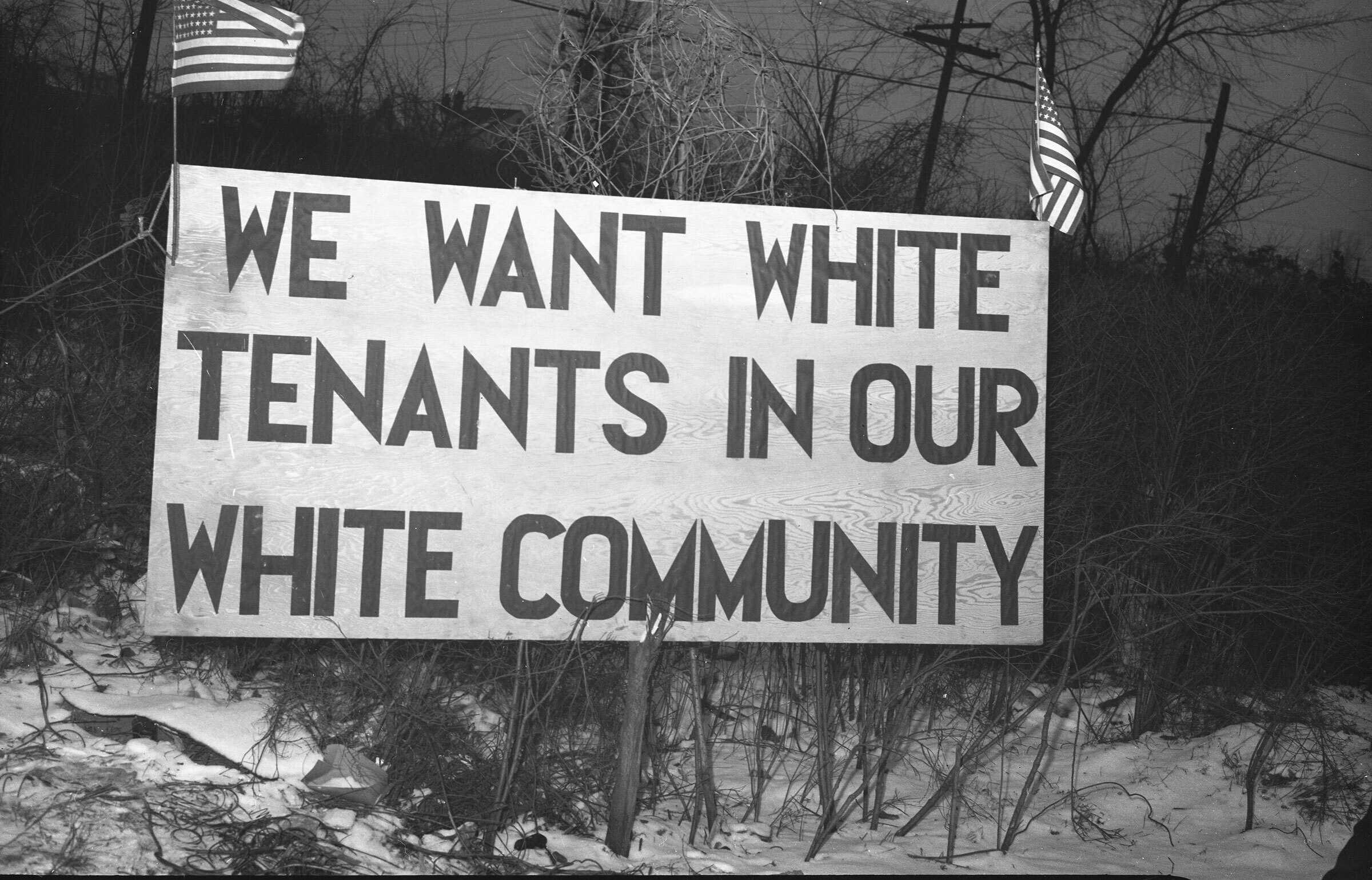 Sign reading "We want white tenants in our white community" directly opposite the Sojourner Truth housing project