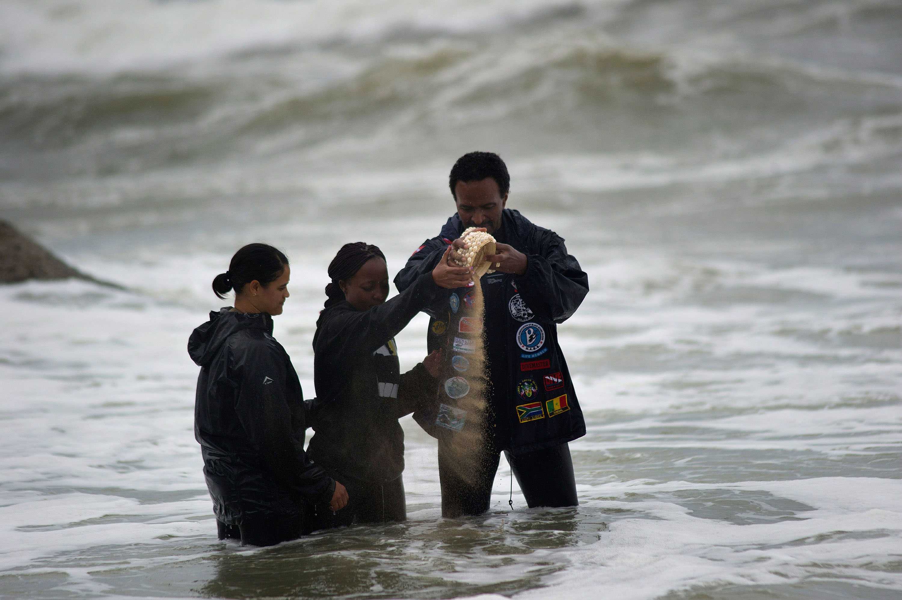 3 divers scatter sand from Mozambique near the site where the wreckage of Portuguese ship Sao Jose-Paquete de Africa .