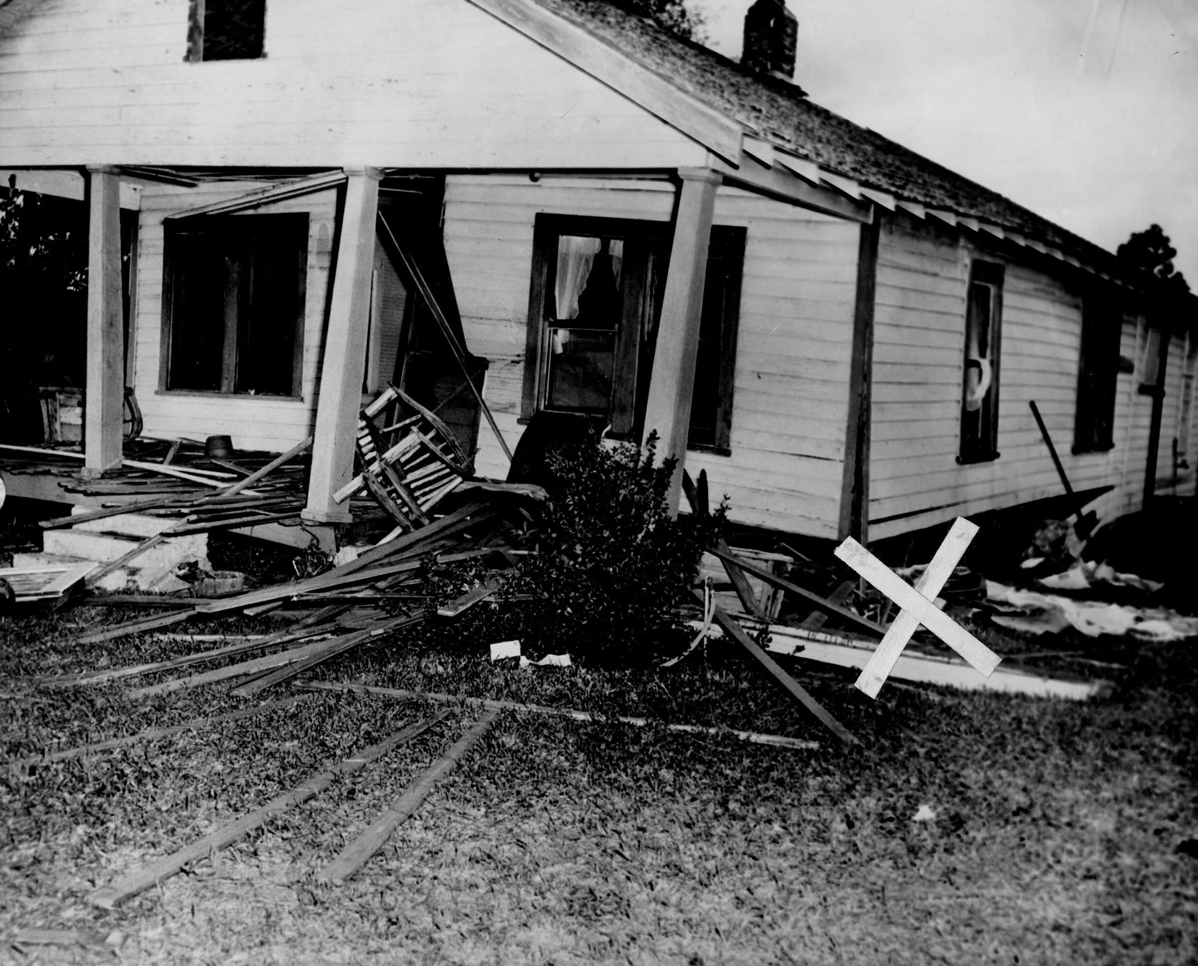 A black and white photograph of Harry and Harriette Moore damaged home after a Christmas day bombing.