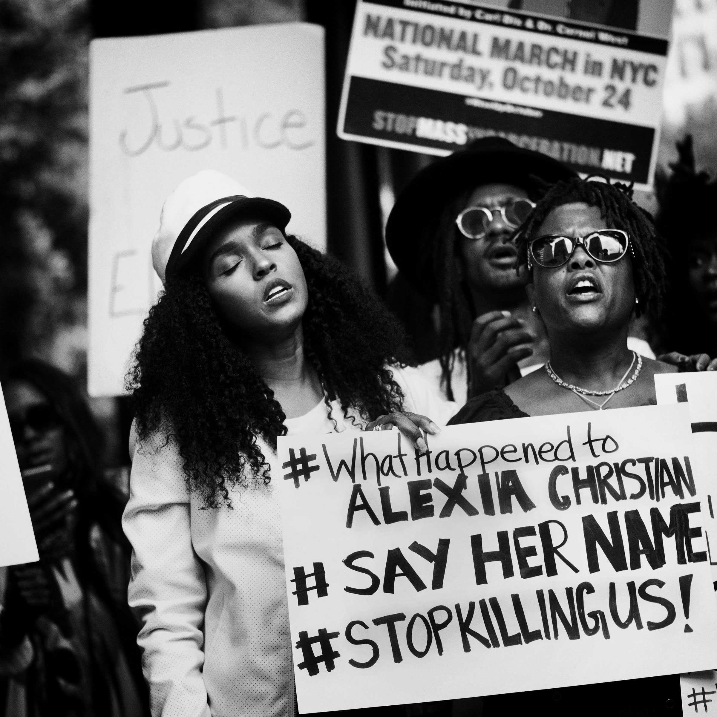 A black-and-white image of Janelle Monáe singing, with her eyes closed, at a Black Lives Matter protest. Alexia Christian's mother holding a protest sign.