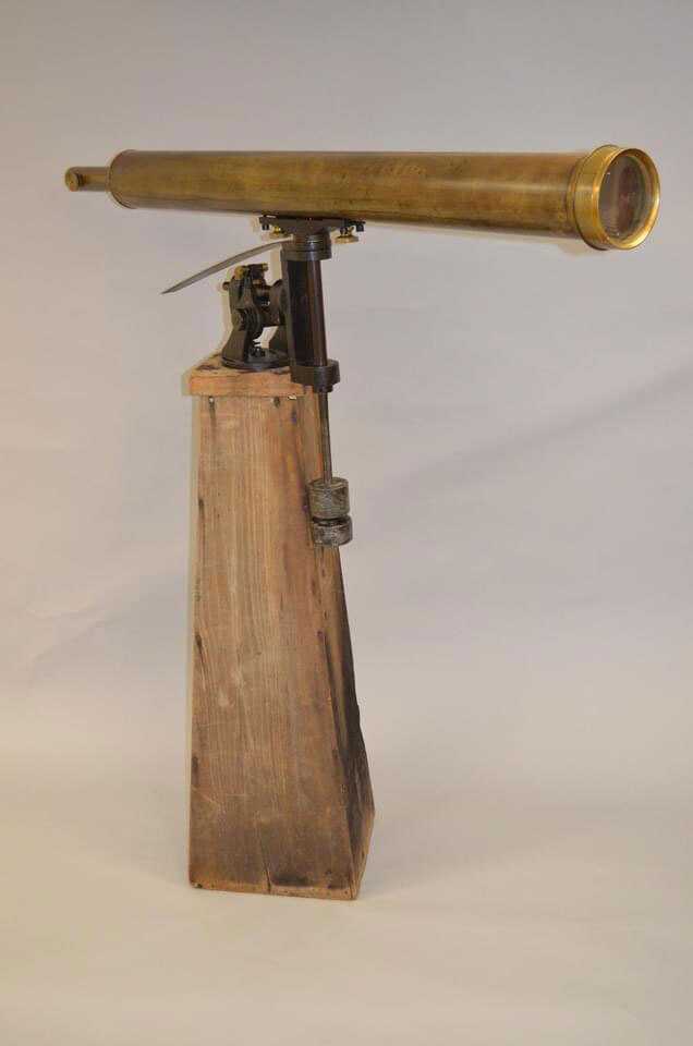 Brass telescope mounted on wooden mount.