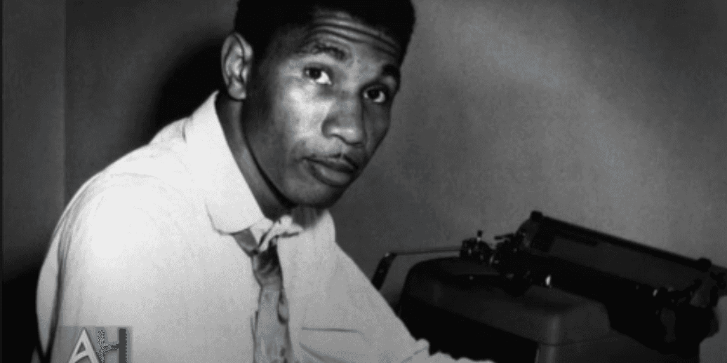 Black and white photograph of Medgar Evers with typewriter