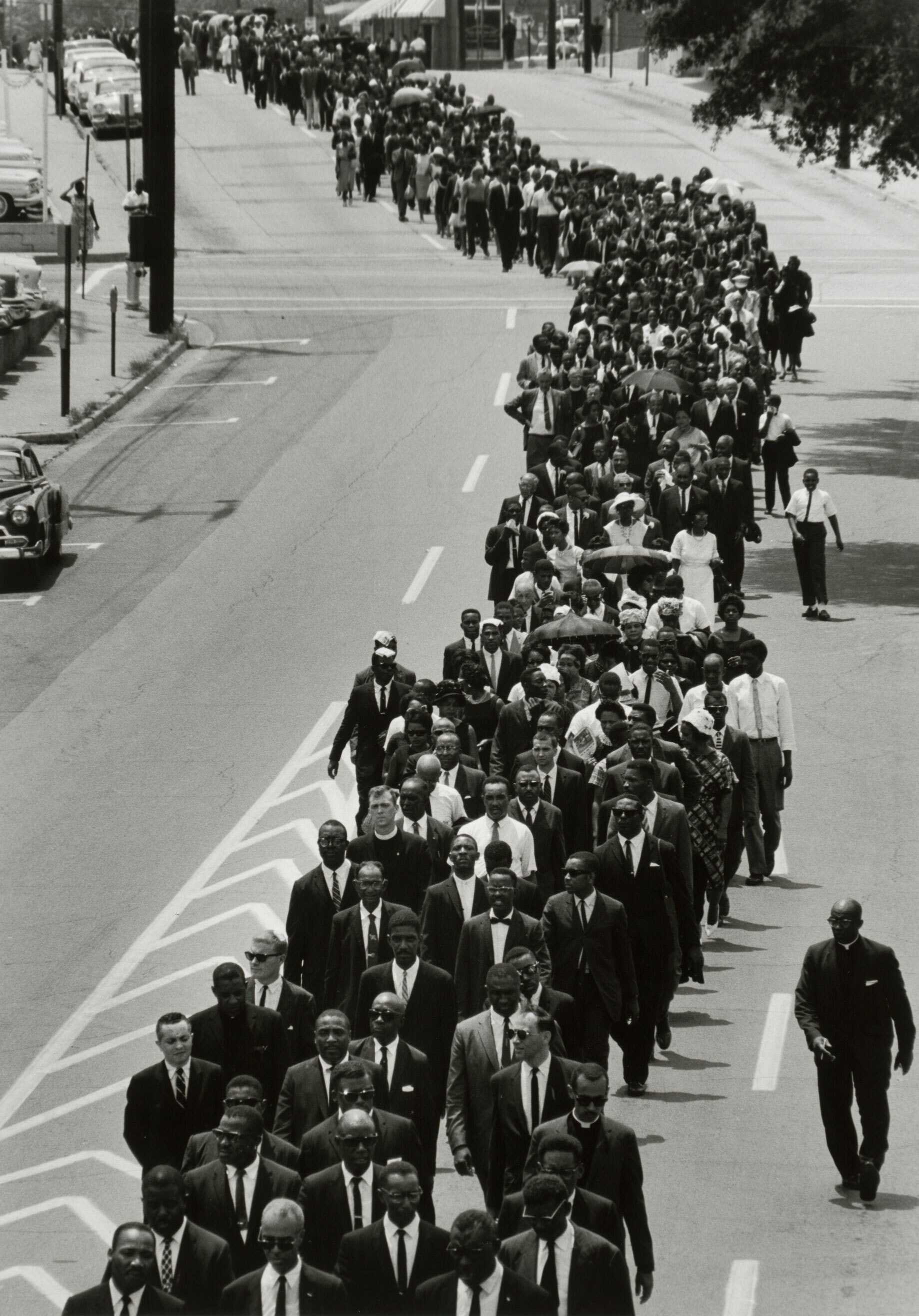 Black and white photograph of lengthy funeral procession for Medgar Evers.