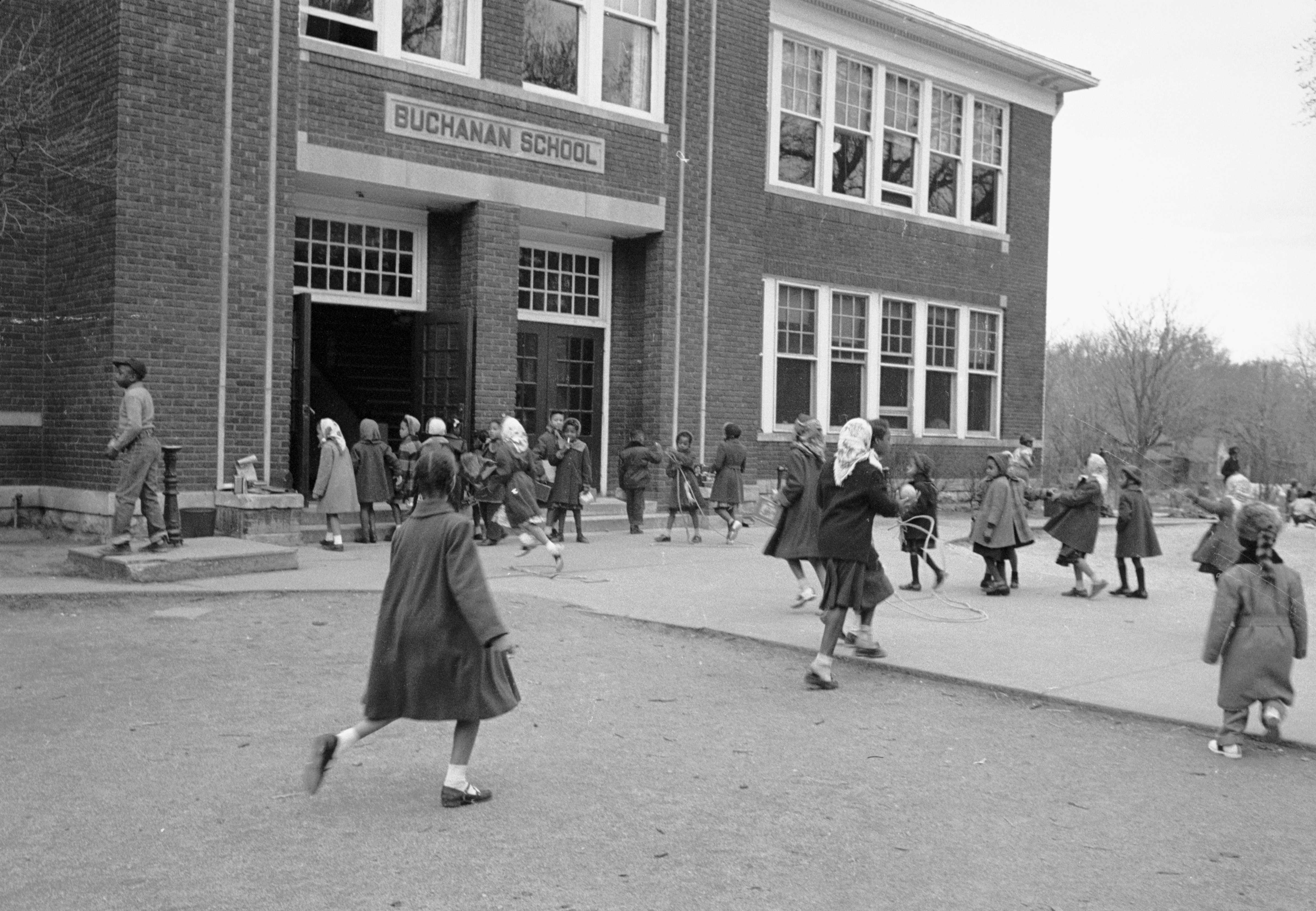 Black and white photograph of African-American students playing outside the Buchanan School.