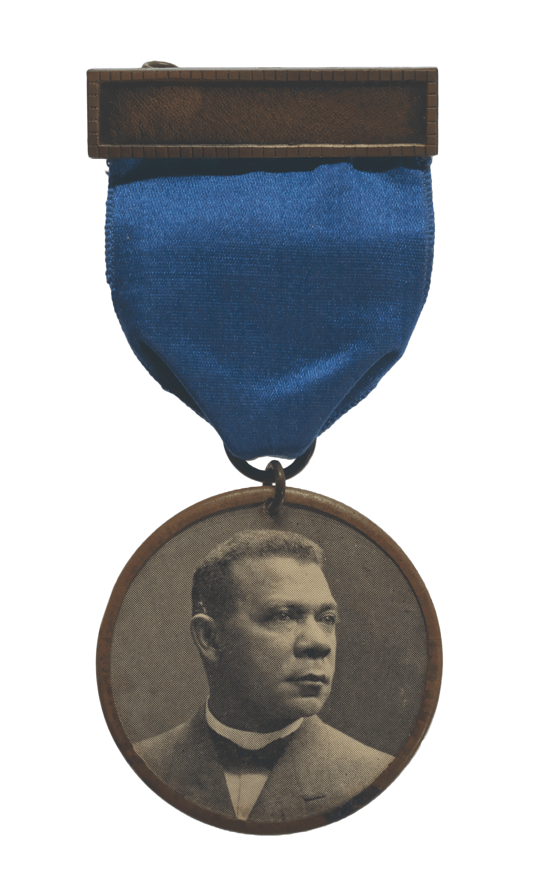 A badge with a blue ribbon and metal clasp. The front has a portrait of Booker T. Washington.