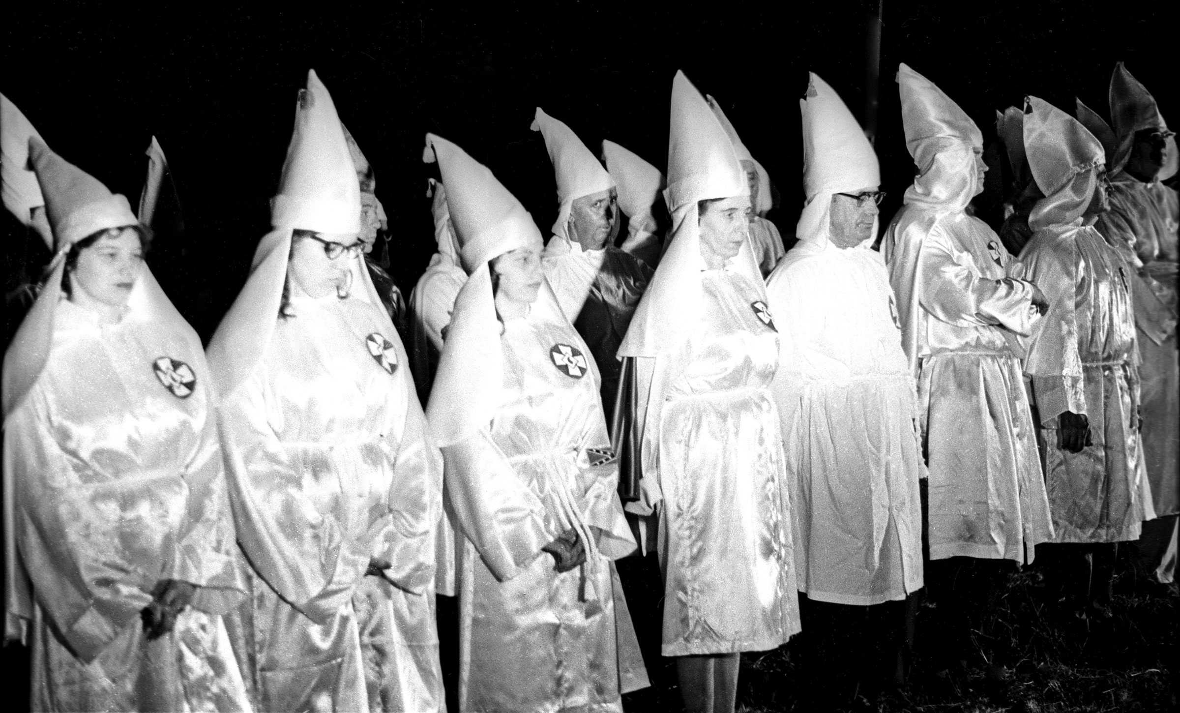 A black and white photograph of unnmasked KKK member standing side by side.