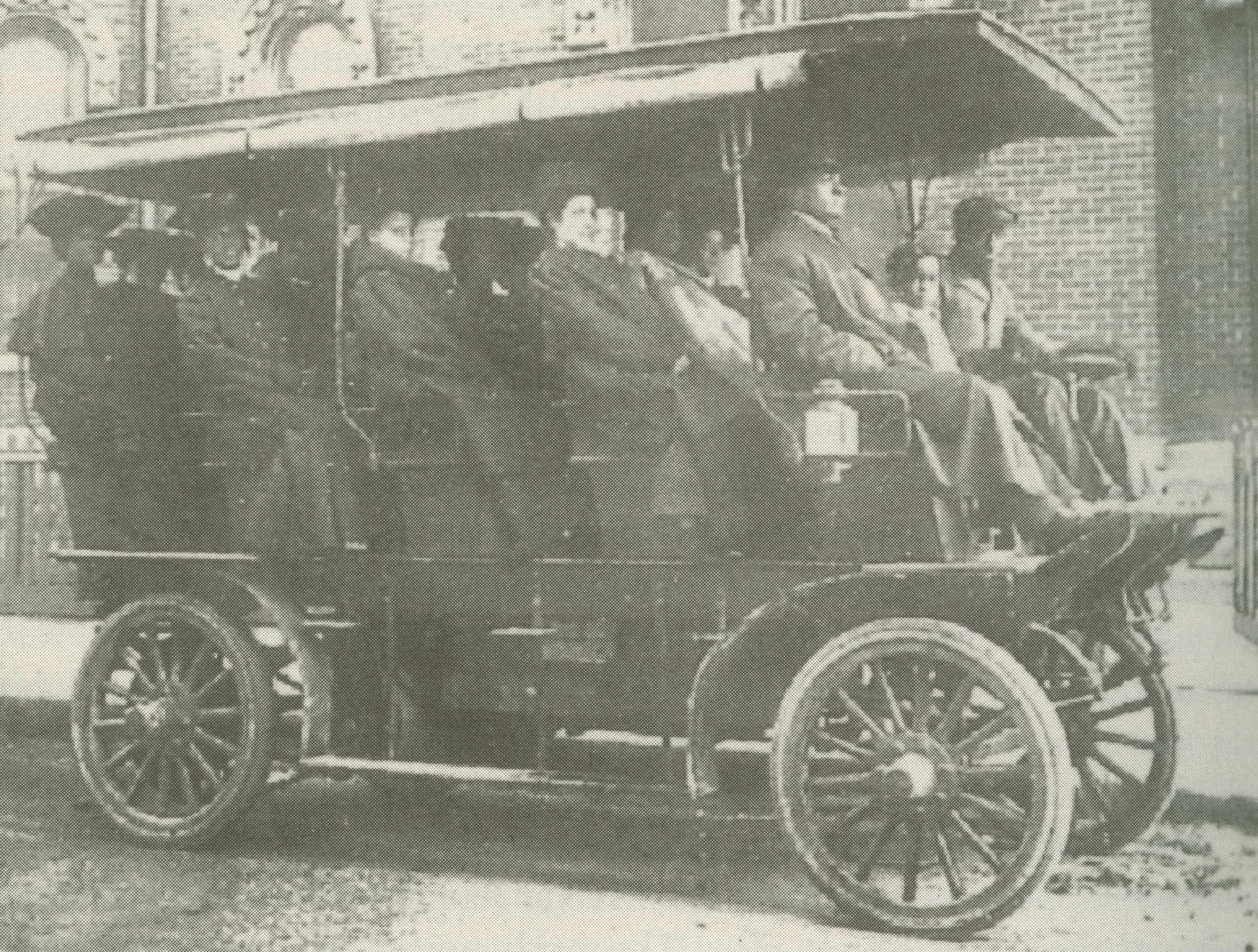 A faded and blurry photograph of a streetcar filled with white and Black passengers.