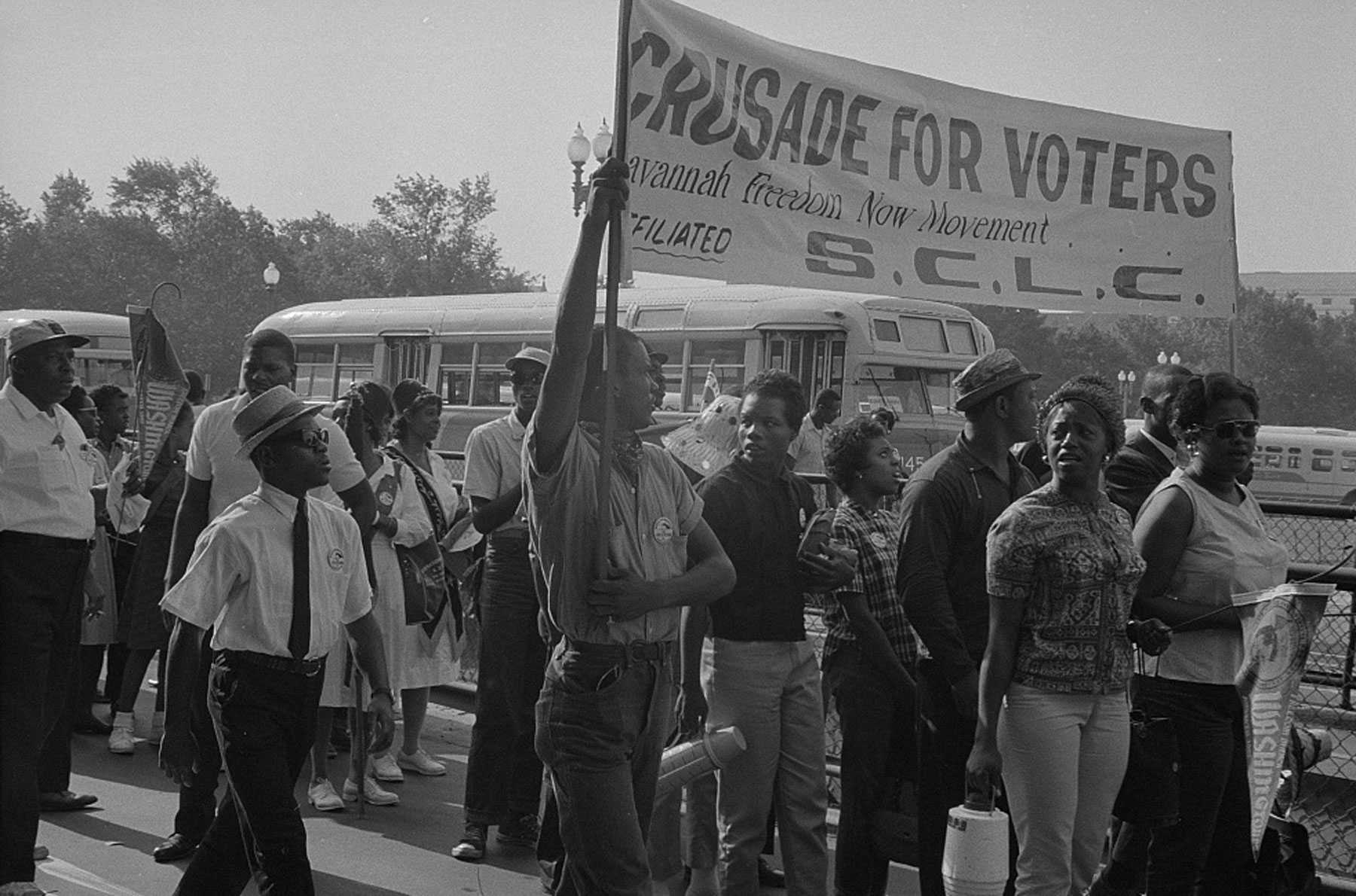 A black and white photograph of marchers with SCLC sign that says "Crusade for Voters"