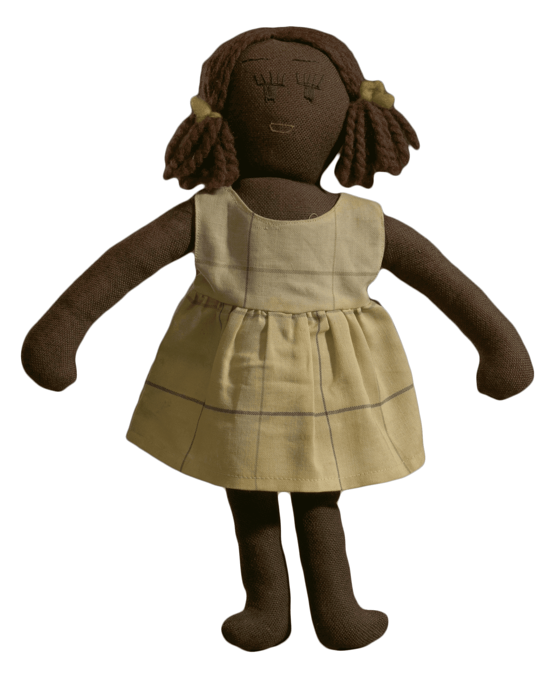 A female cloth doll. Her hair is in pigtails with cloth bows. She is wearing a tan dress with stripes.