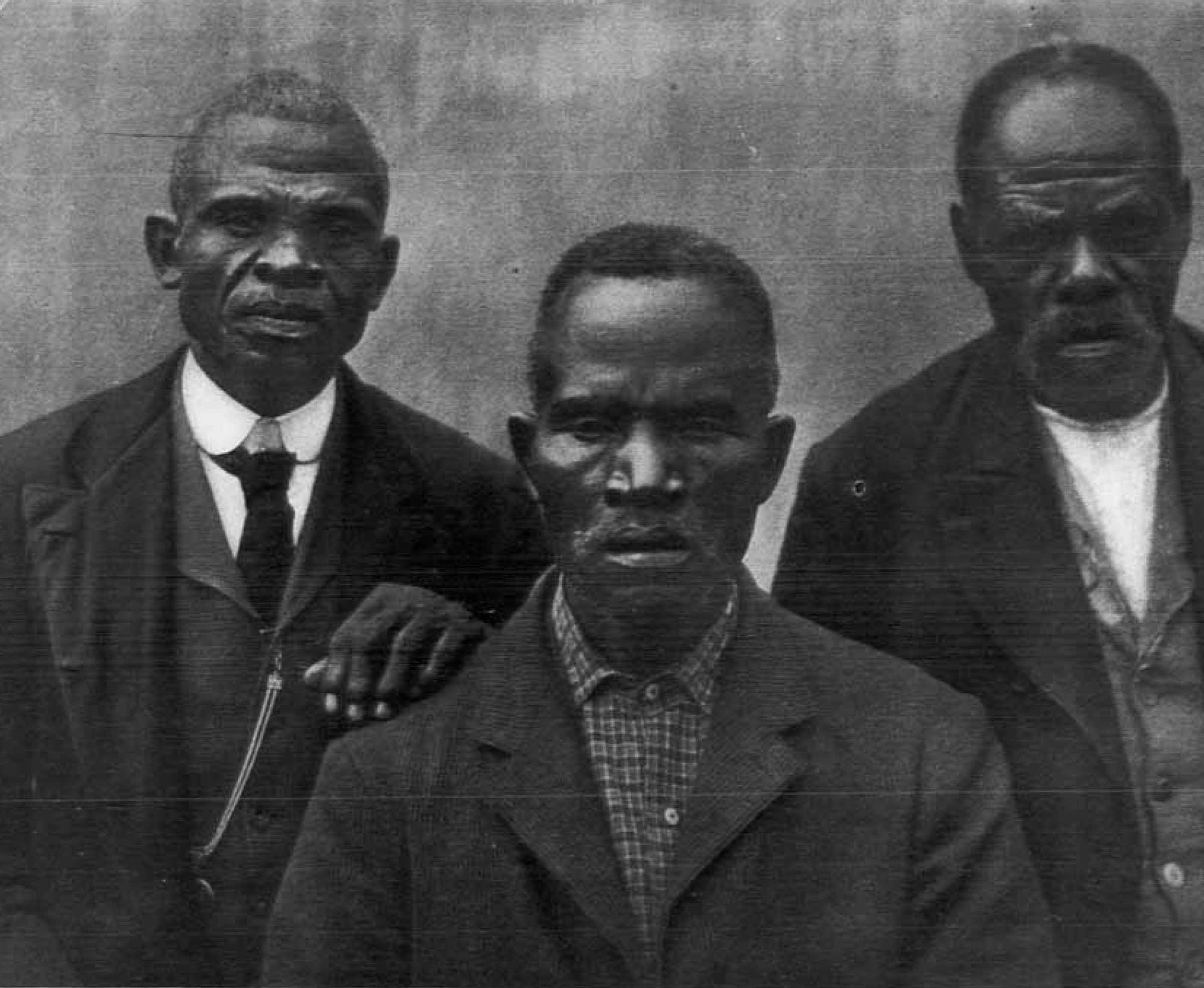 A black and white photograph of 3 survivor of the Wanderer. They are older men well dressed in suit jackets.