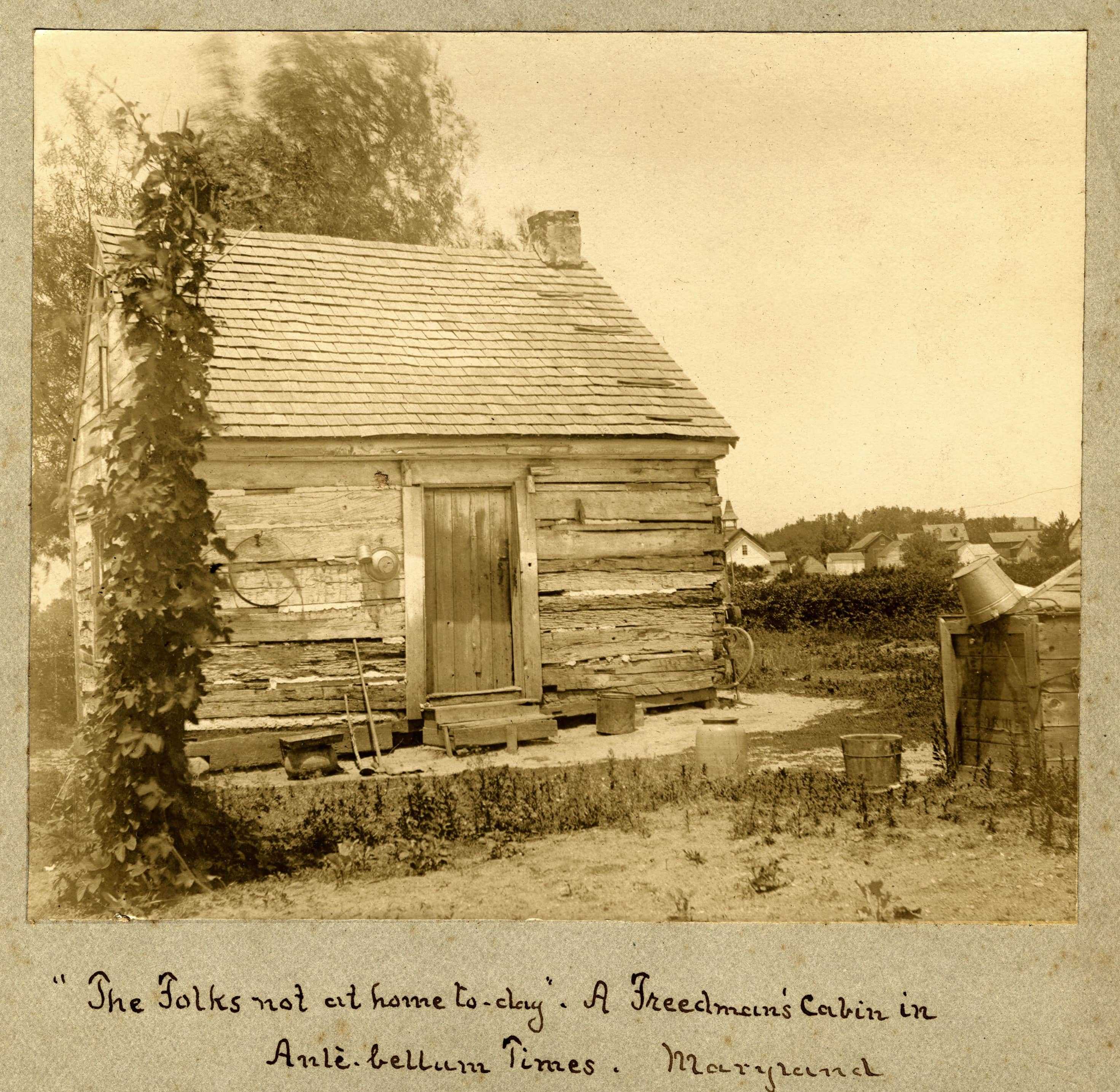 A sepia toned photograph of a Freedman's Cabin. A hand written note about the cabin is below.