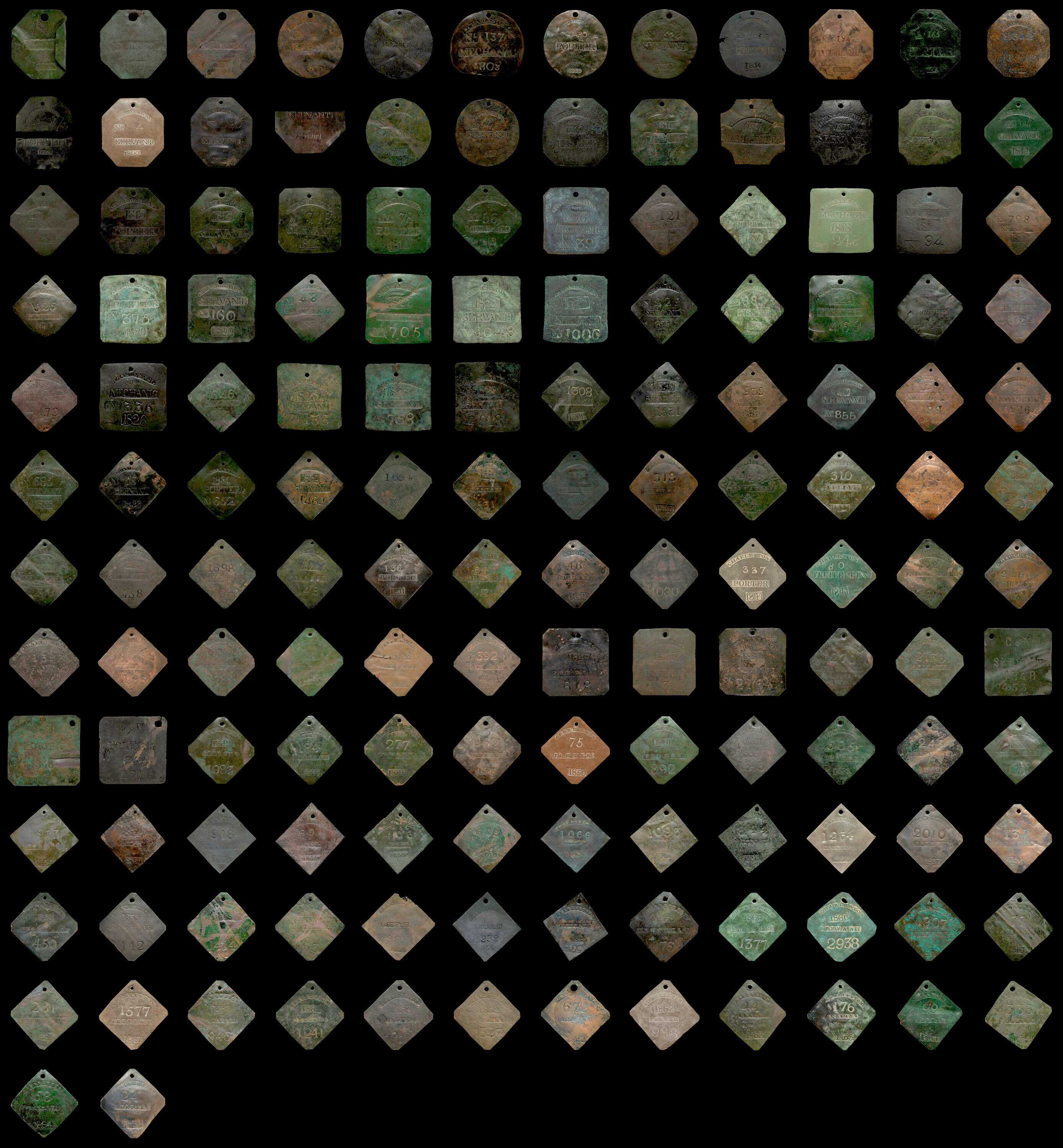 Composite view of 146 slave badges photographed on a black background.  The badges are square, round and diamond shaped.