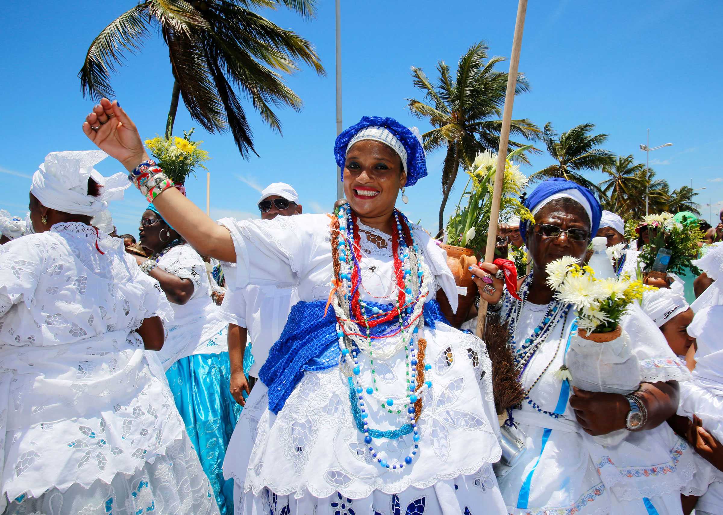 Procession before the Lavagem. Group of woman dressed in elaborate white dressed with accent  of blue beads and scarfs.