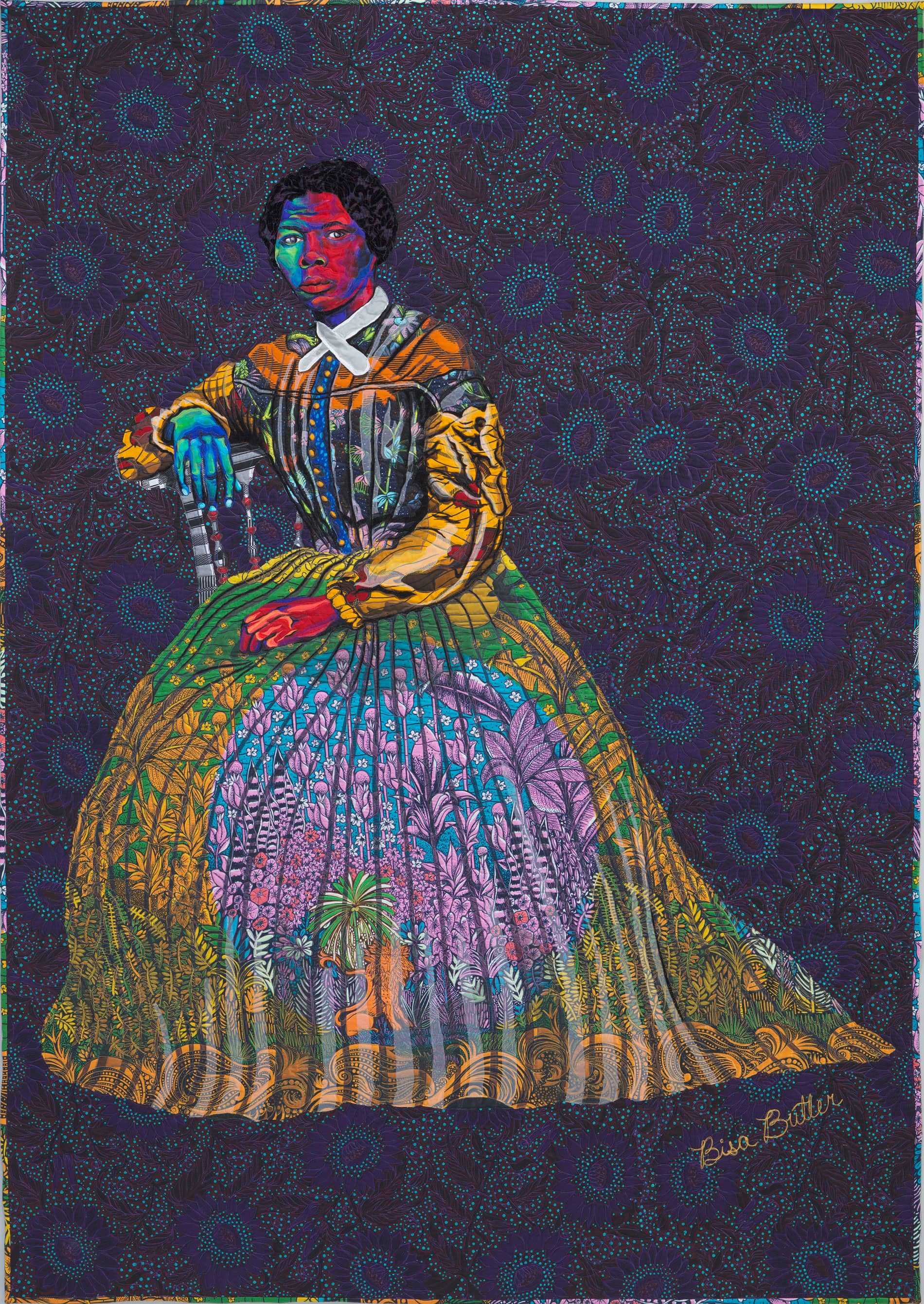 A quilted textile portrait of Harriet Tubman, inspired by Benjamin F. Powelson's photograph. Tubman sits against a dark floral background in vibrant fabrics.