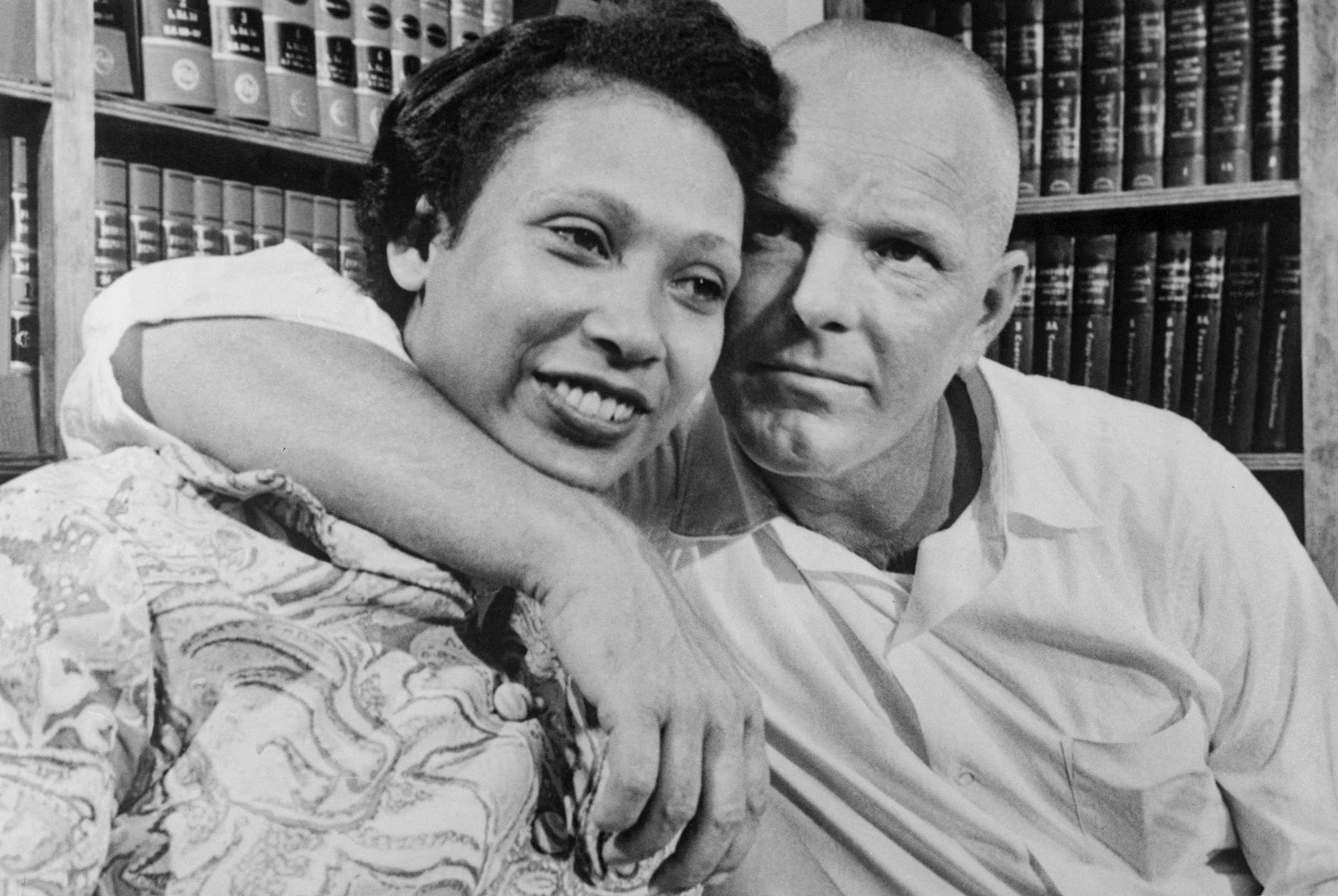 Lovingly, Richard Loving rest his head against Mildred Loving as he wraps his arm around her shoulder.