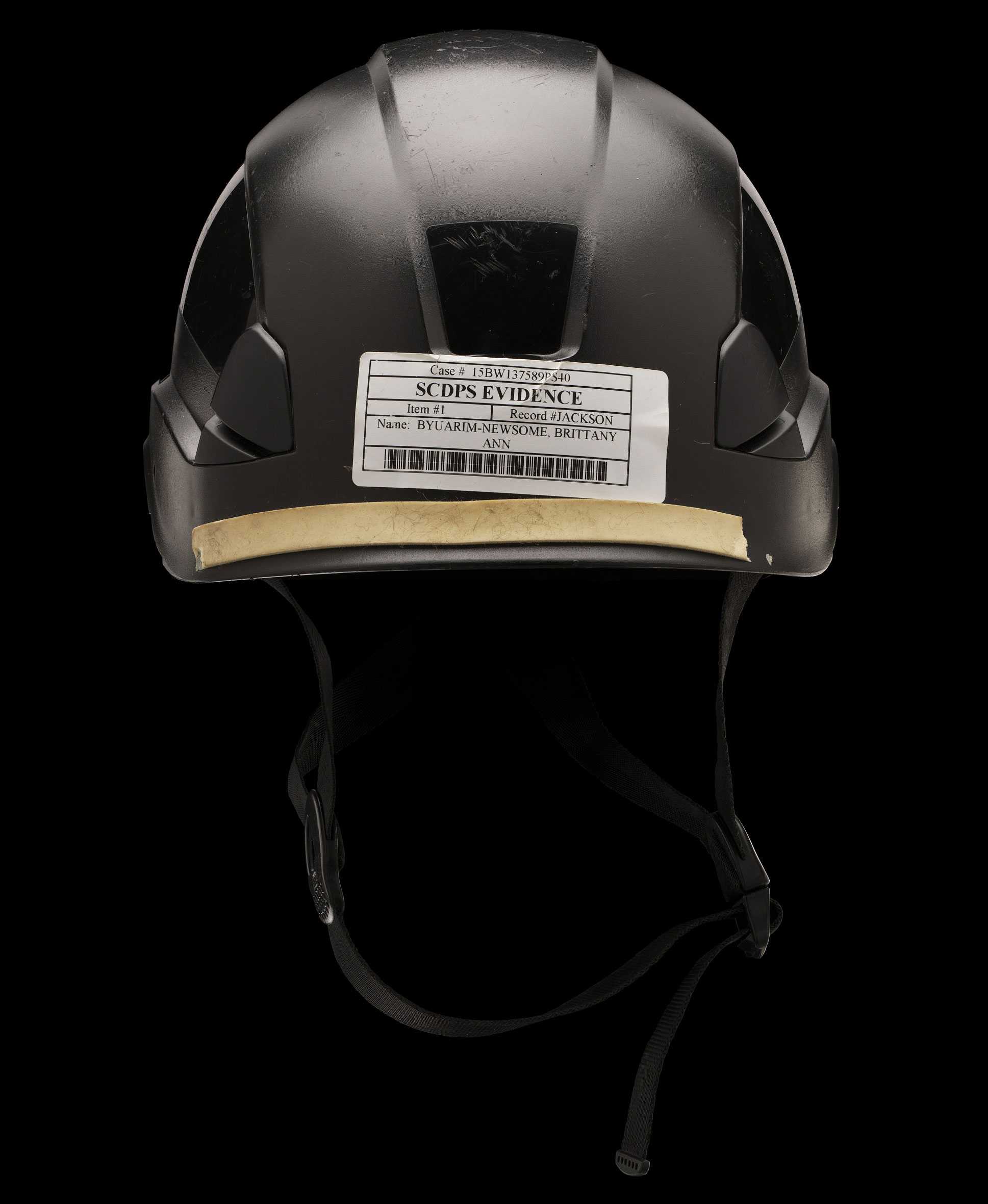 A black helmet with a sticker on the back that says 'Evidence'