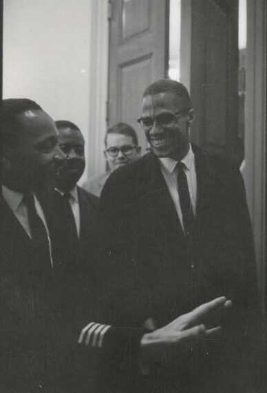 Black and white photograph of Malcolm X and Martin Luther King Jr.
