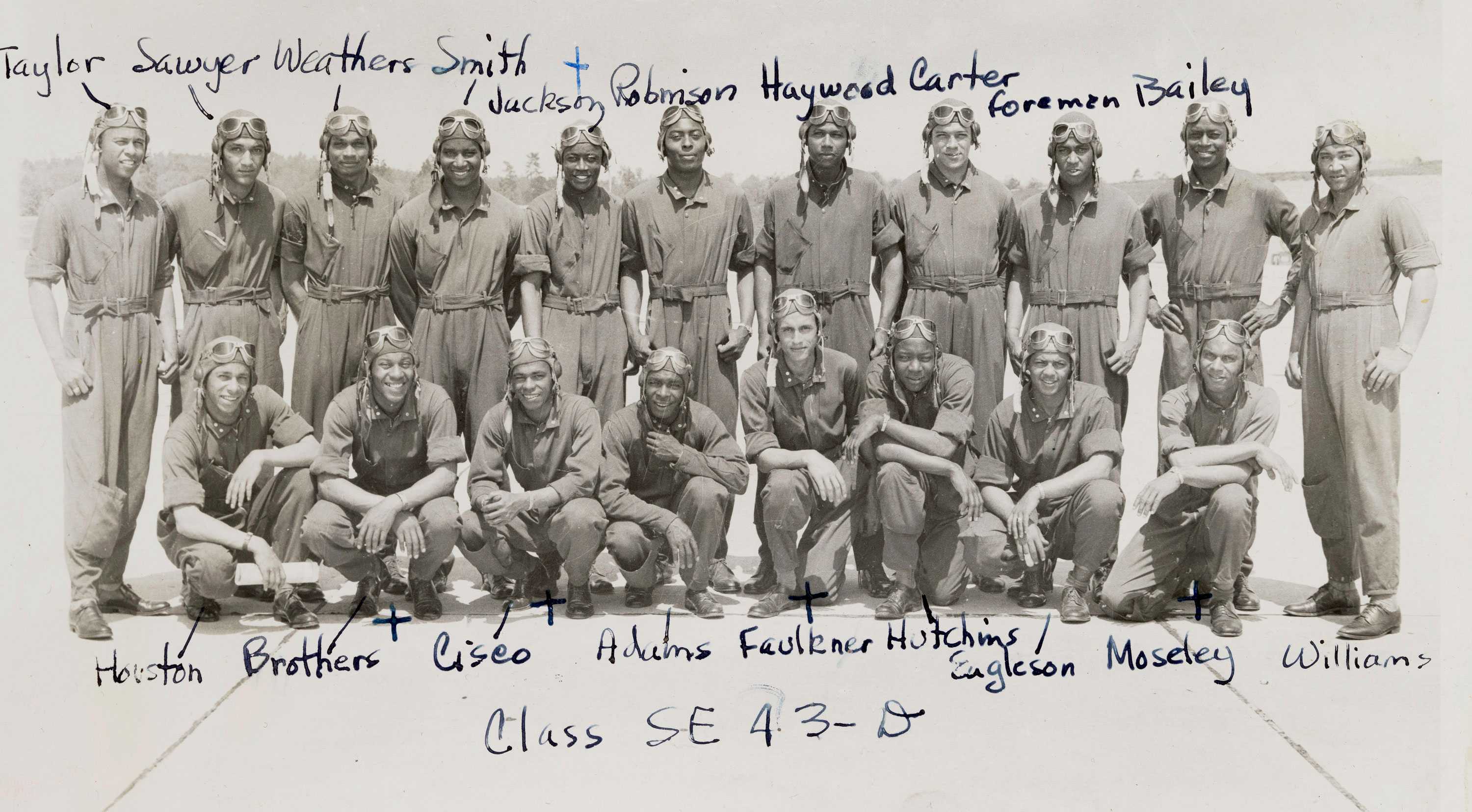 A black and white photograph from a photo album of nineteen members of the Tuskegee Airmen class SE-43-D.