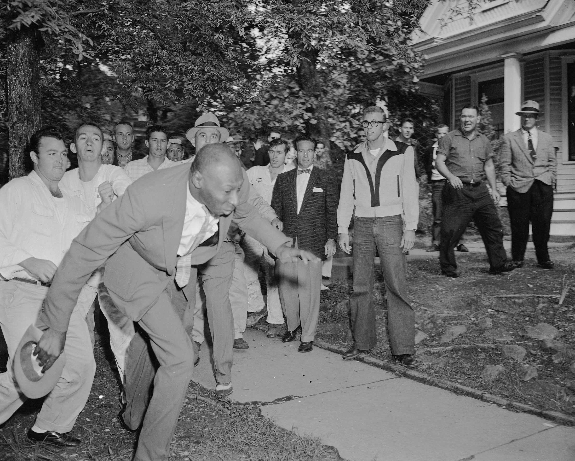 A photograph of Alex Wilson falling after he was shoved by a white mob in front of a street.