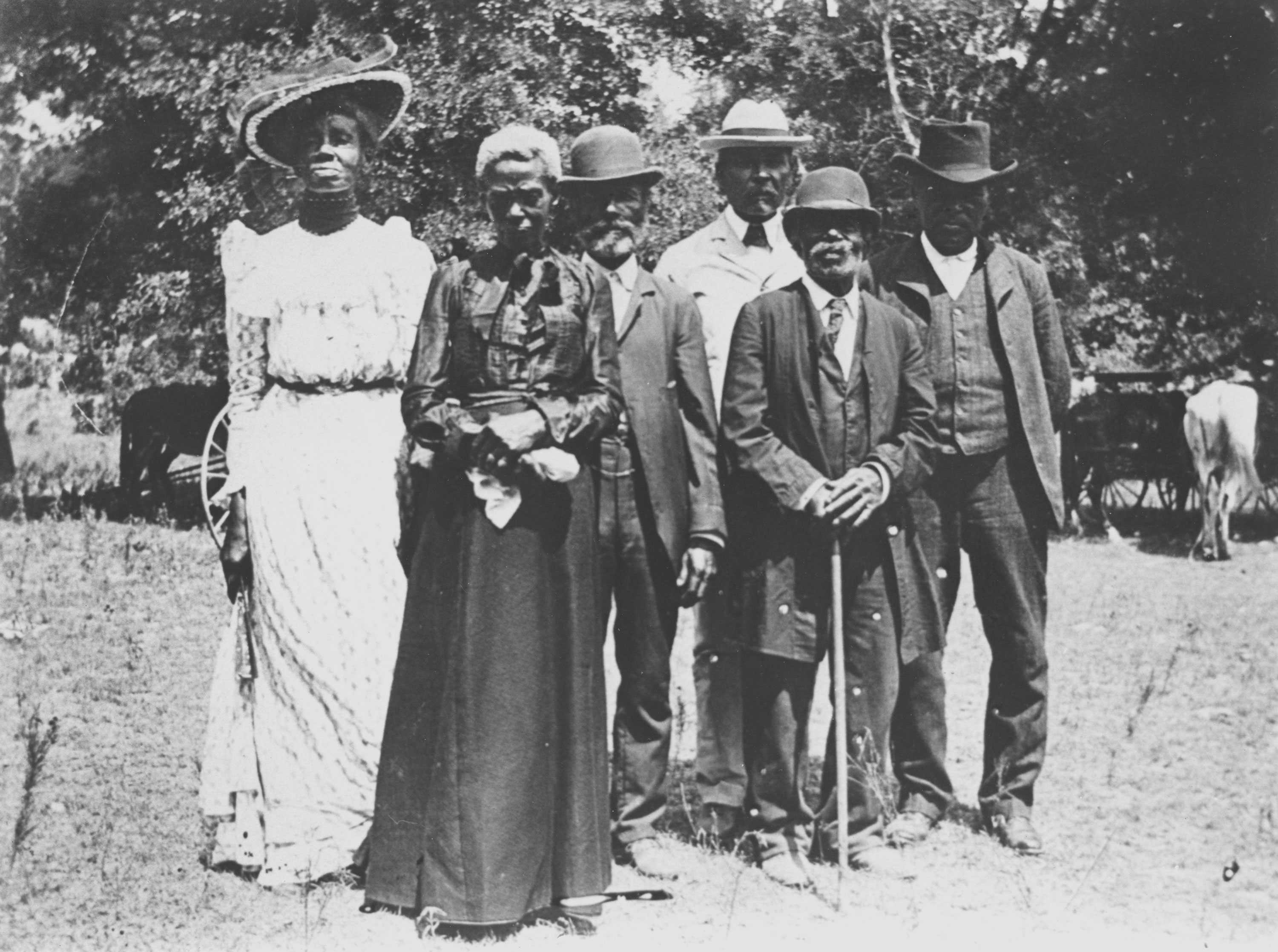 A blurry black and white photograph of a group of people. They are dressed nicely in celebration for Emancipation Day.